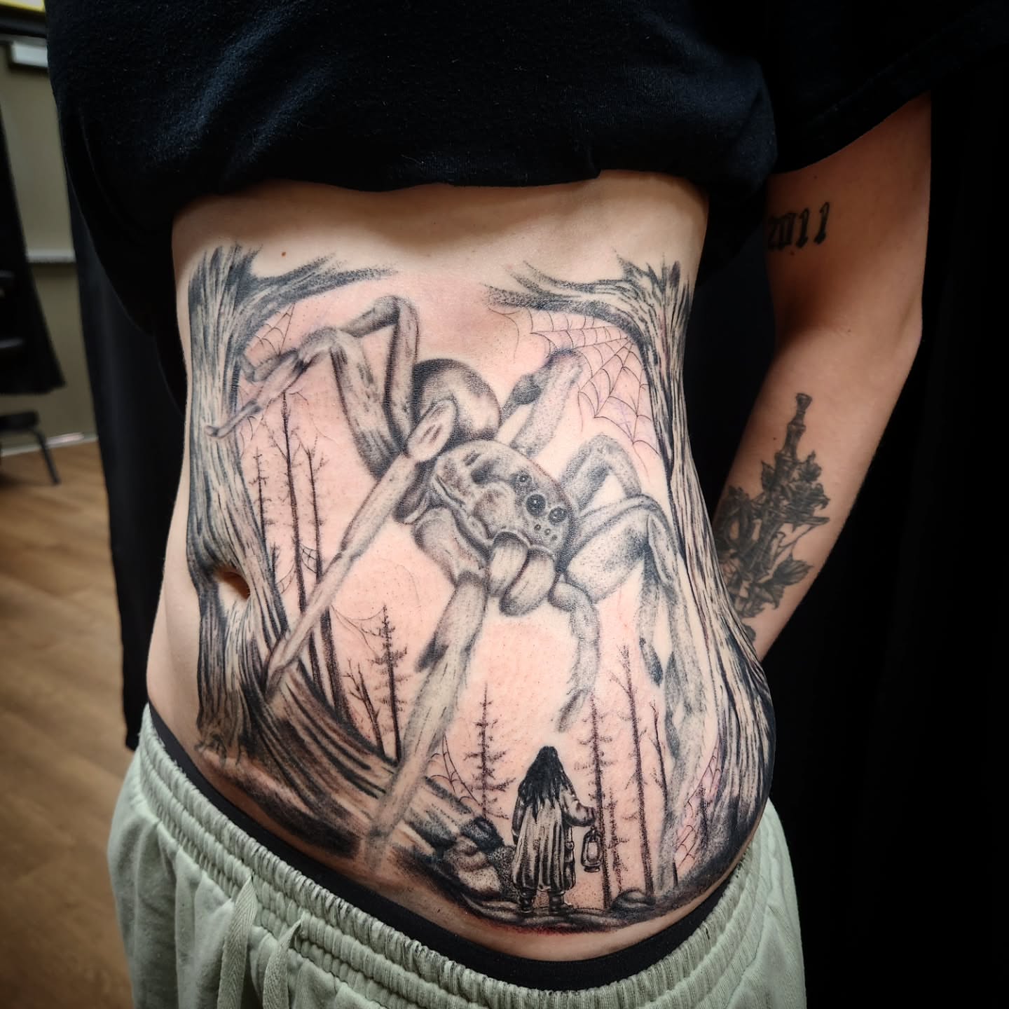 Spider realism tattoo on the torso by Eric Richards