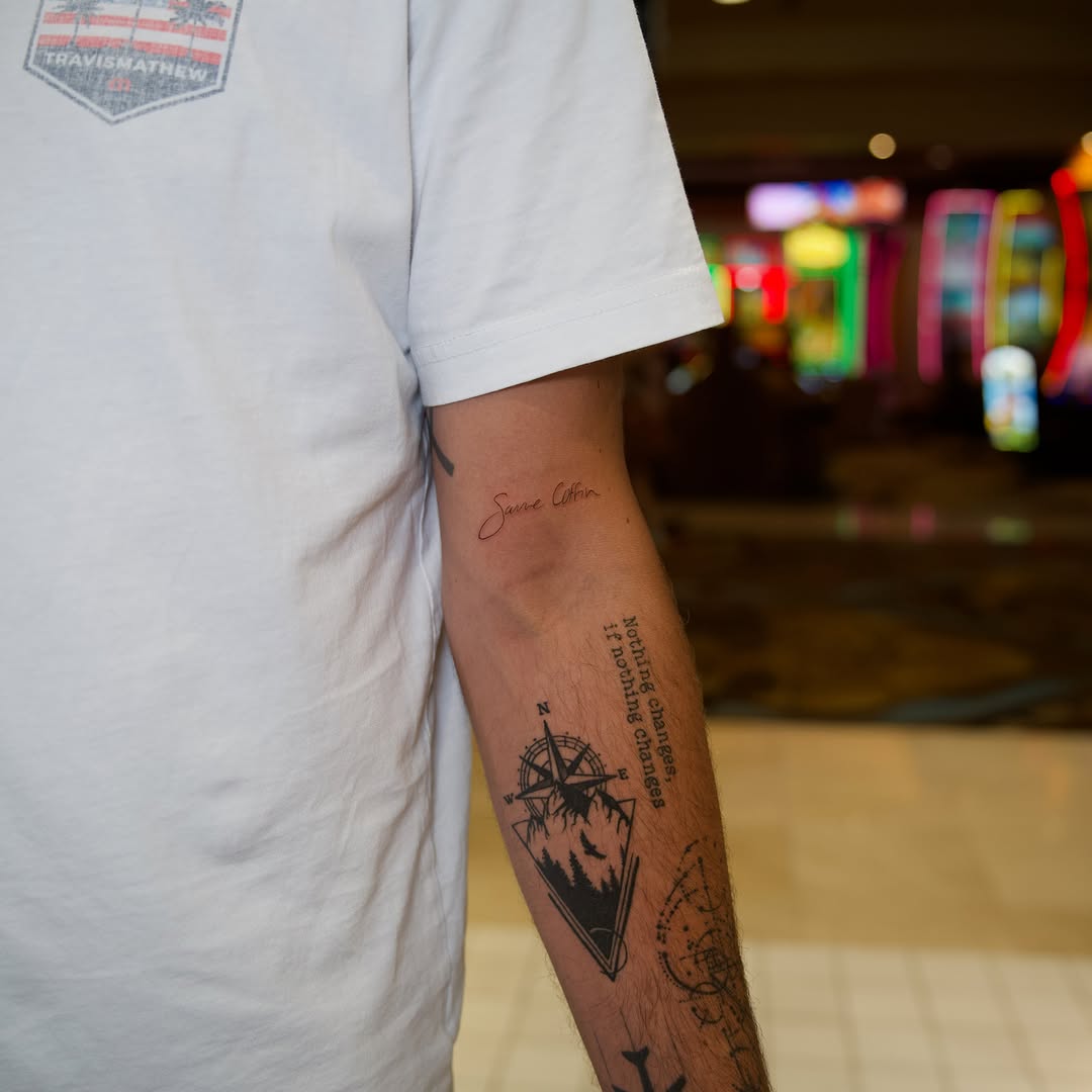 Compass and quote black and grey tattoo on the forearm by Raven Wood