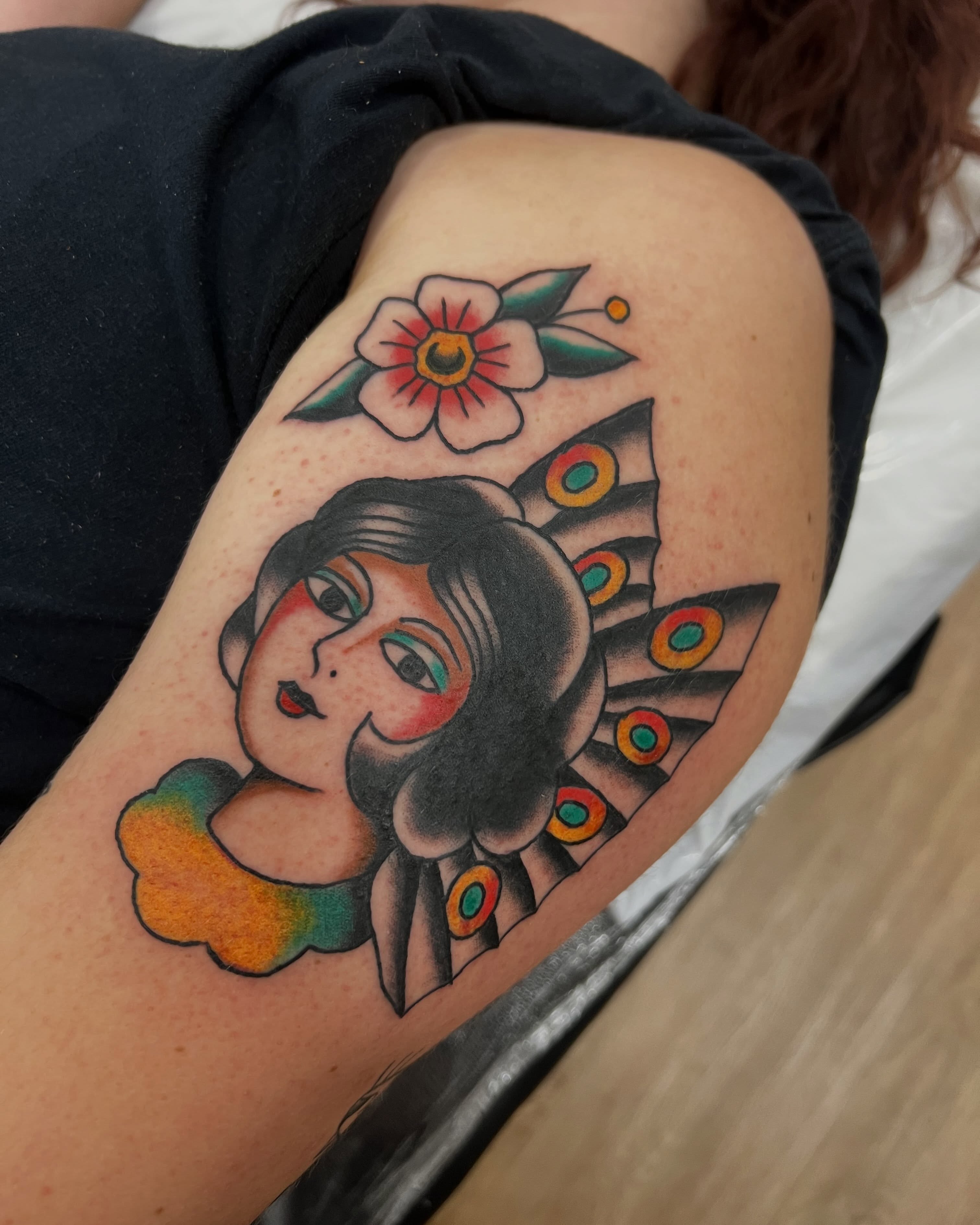 Woman with peacock feathers American traditional tattoo on the shoulder by Samantha Citer