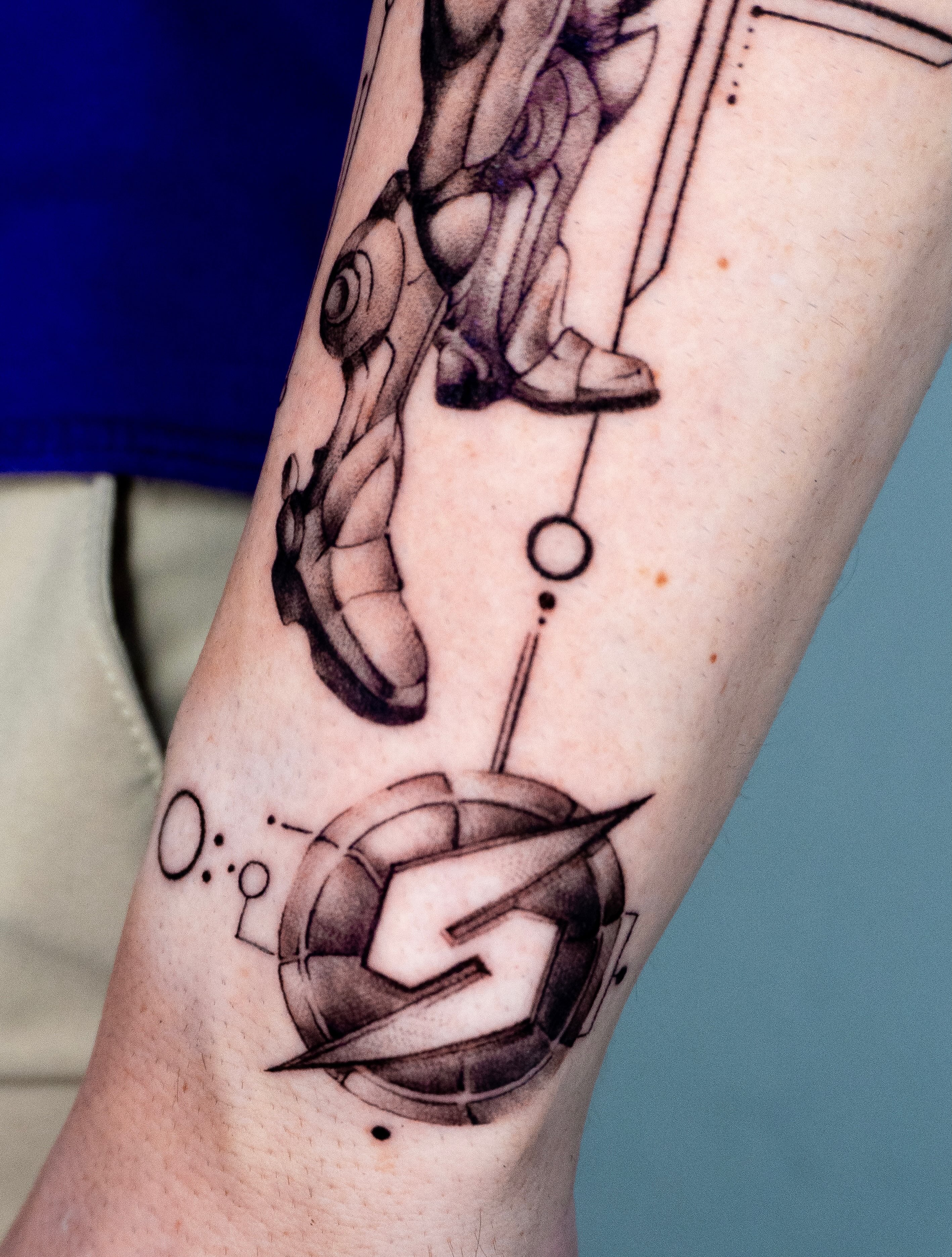 Volleyball geometric tattoo on the forearm by Moi Rivas, Salt Lake City, Utah