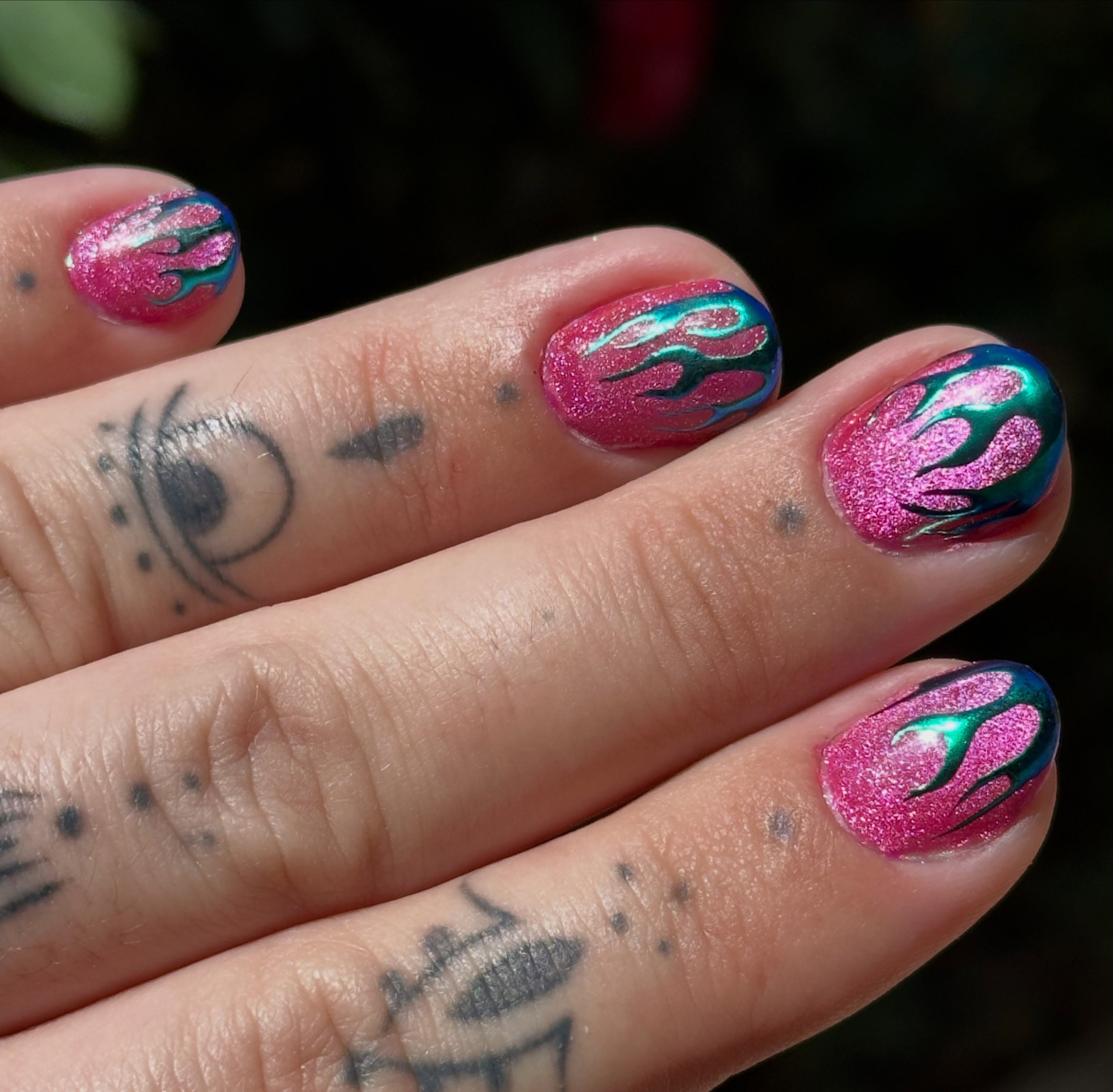 Flame design new school tattoo on the hand by Liz McDonald