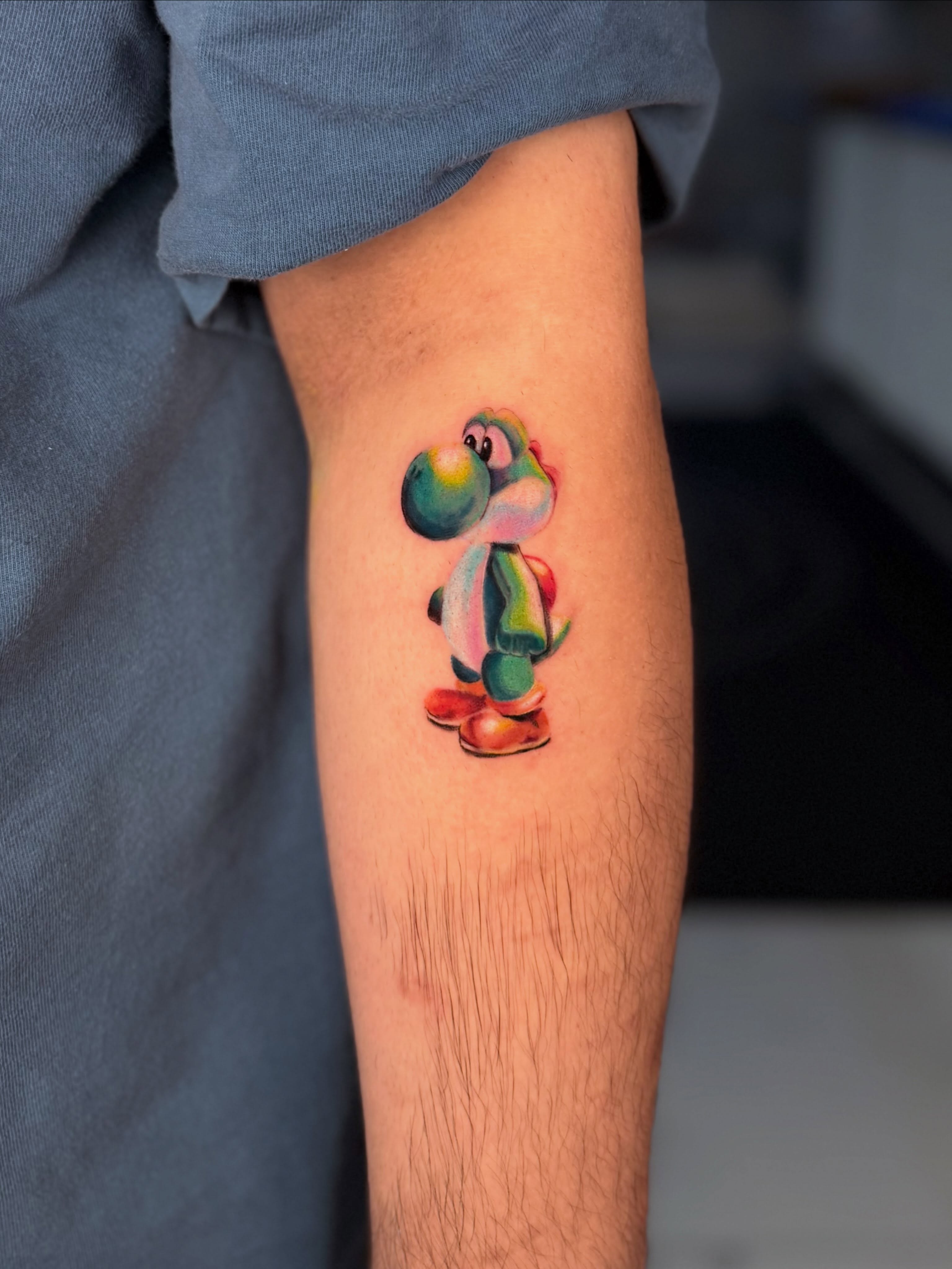 Yoshi watercolor tattoo on the forearm by Idalia Pulido