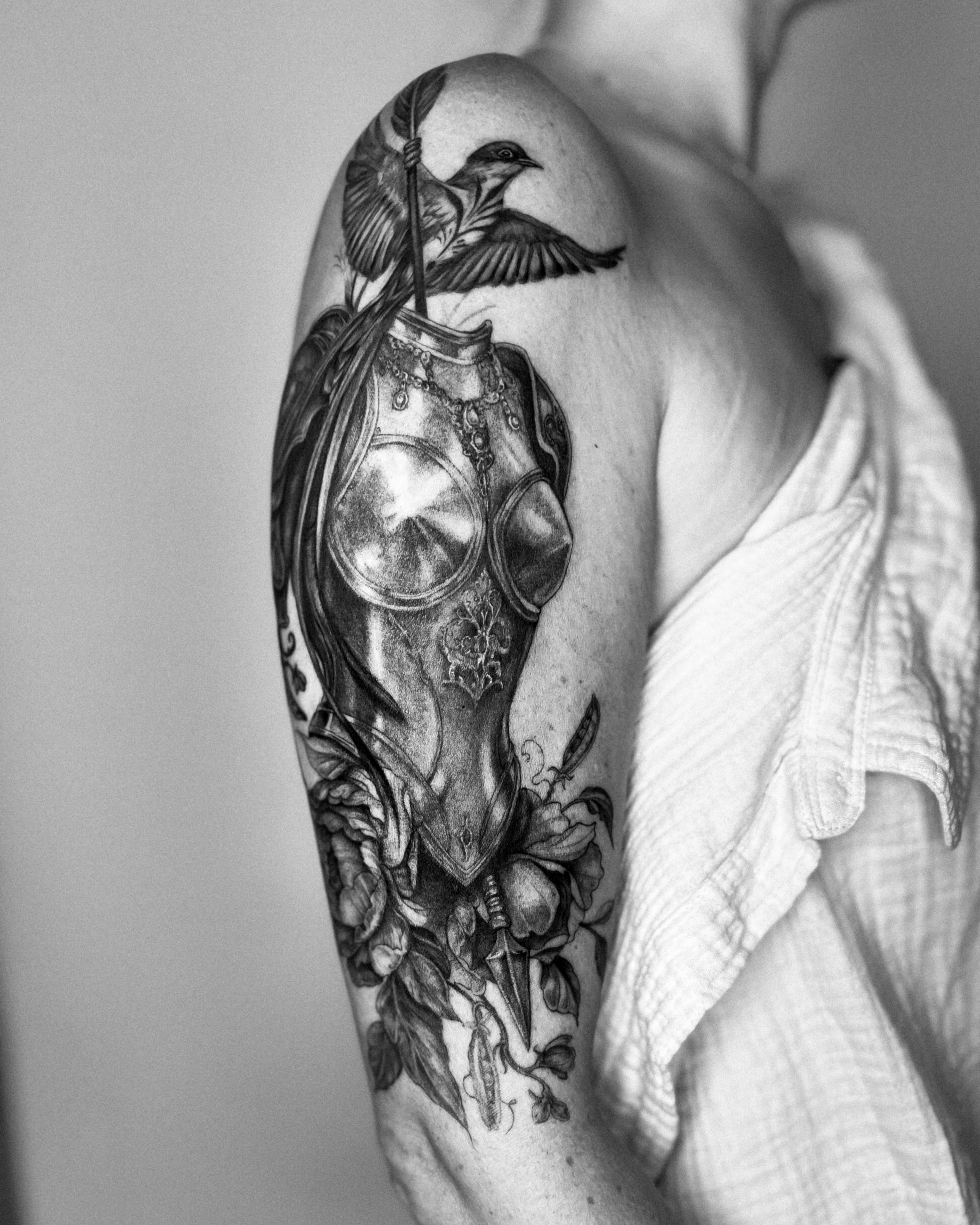 Horse helmet and bird realism tattoo on the shoulder by Ayauna Mai