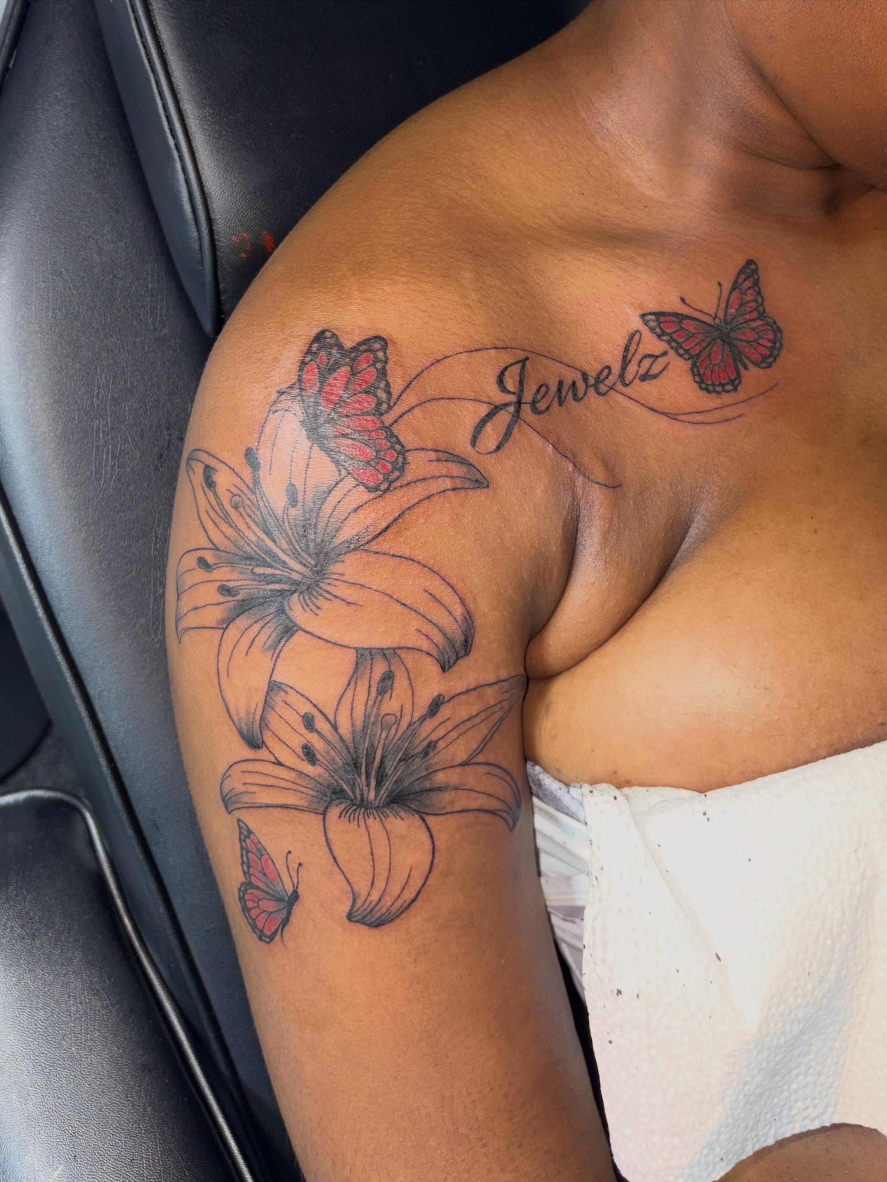 Lilies and butterflies realism tattoo on the shoulder by 216 Tattoos 🥰