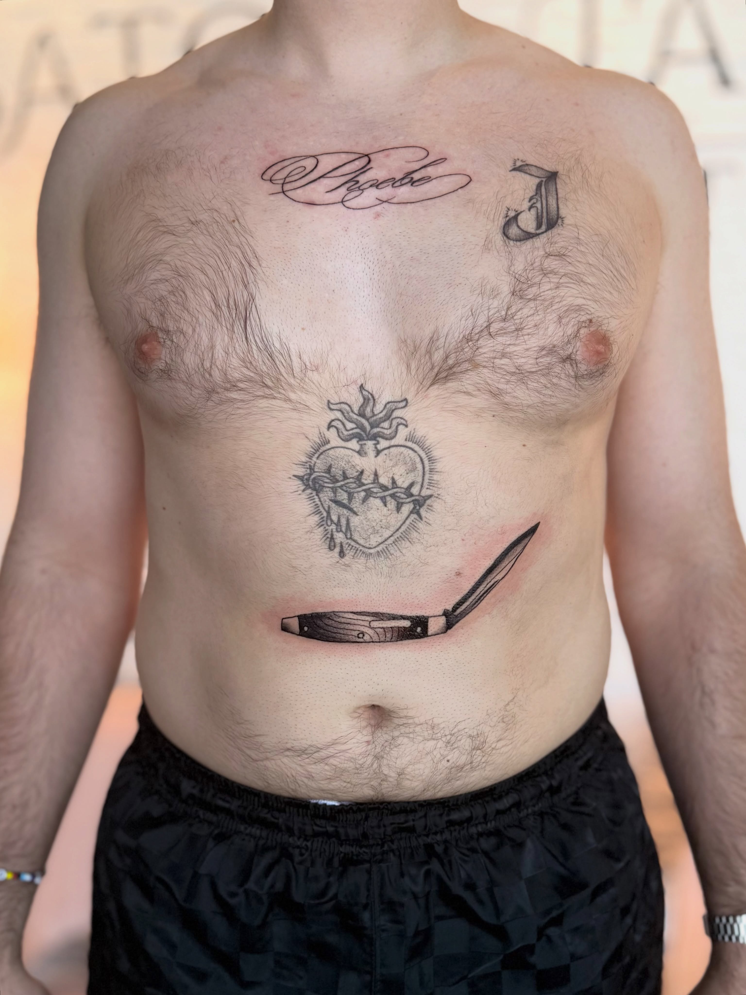 Heart with thorns black and grey tattoo on the chest by Kyndall Lynn, Waxahachie, Texas