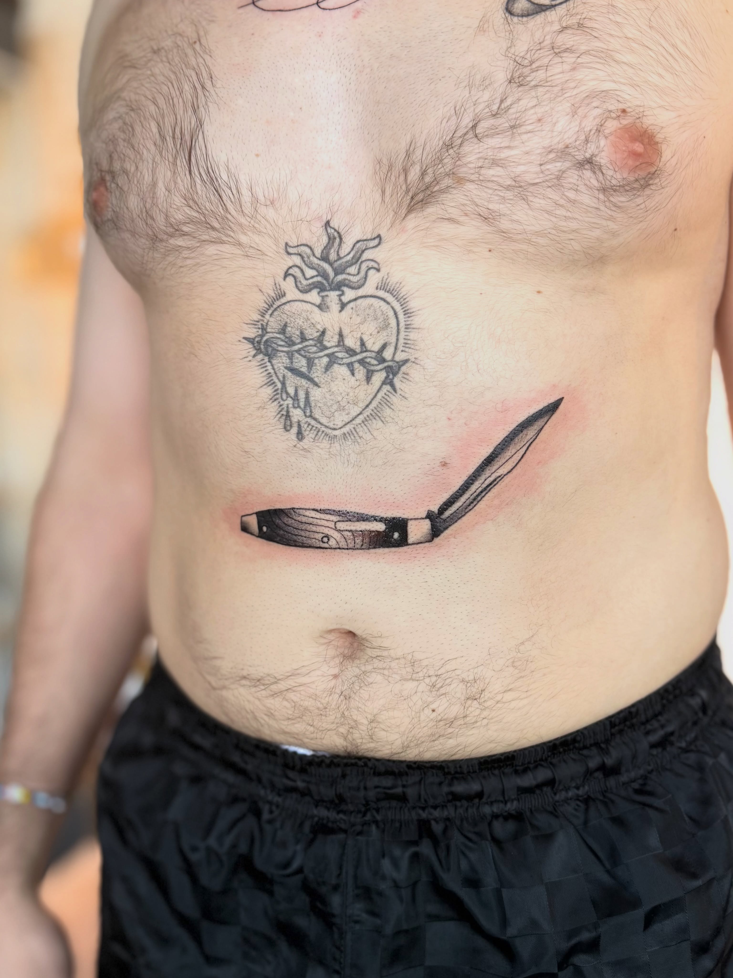 Heart with thorns black and grey tattoo on the chest by Kyndall Lynn, Waxahachie, Texas
