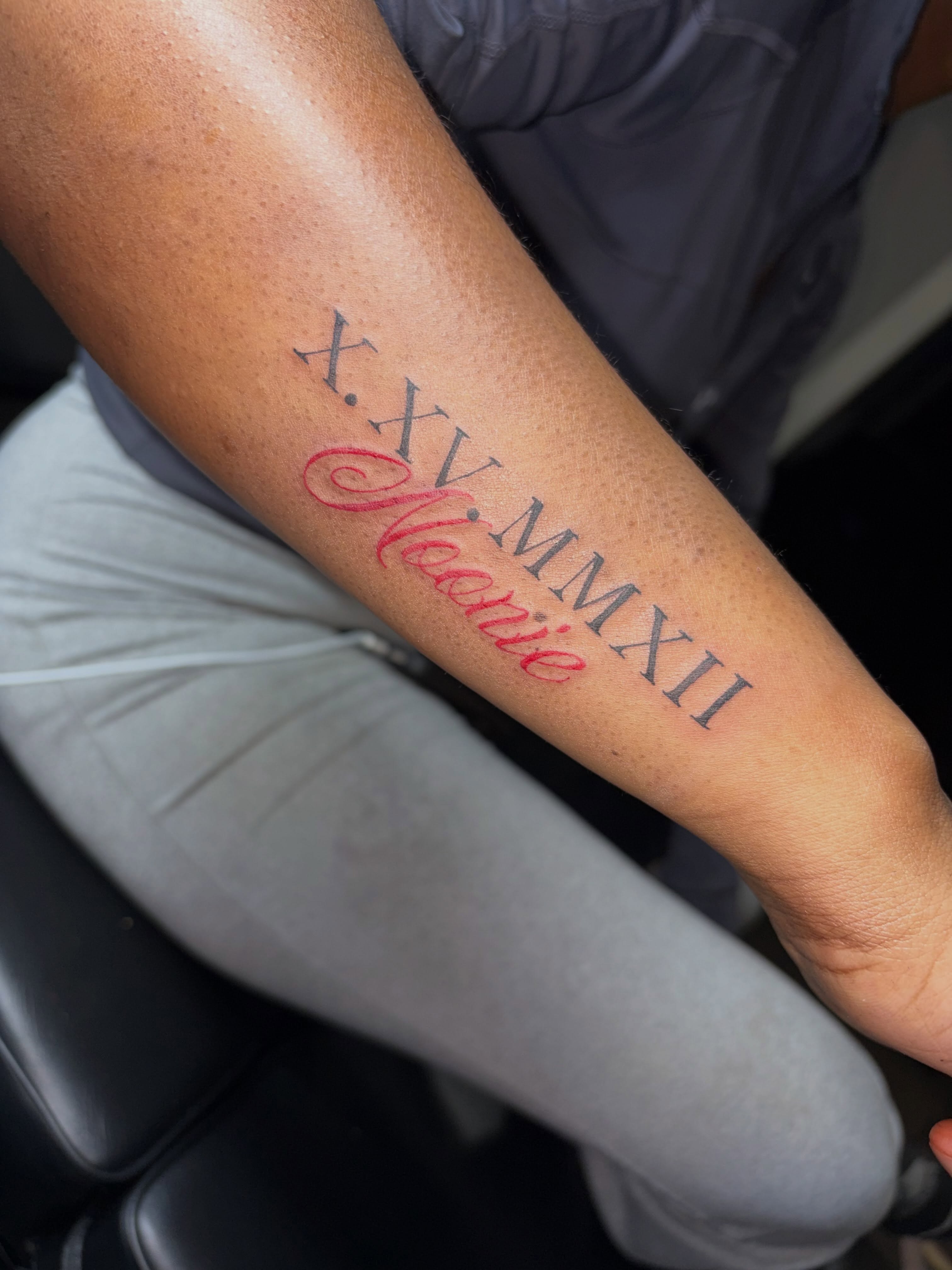 Cross, Roman numerals, name lettering script tattoo on the forearm by 216 Tattoos 🥰