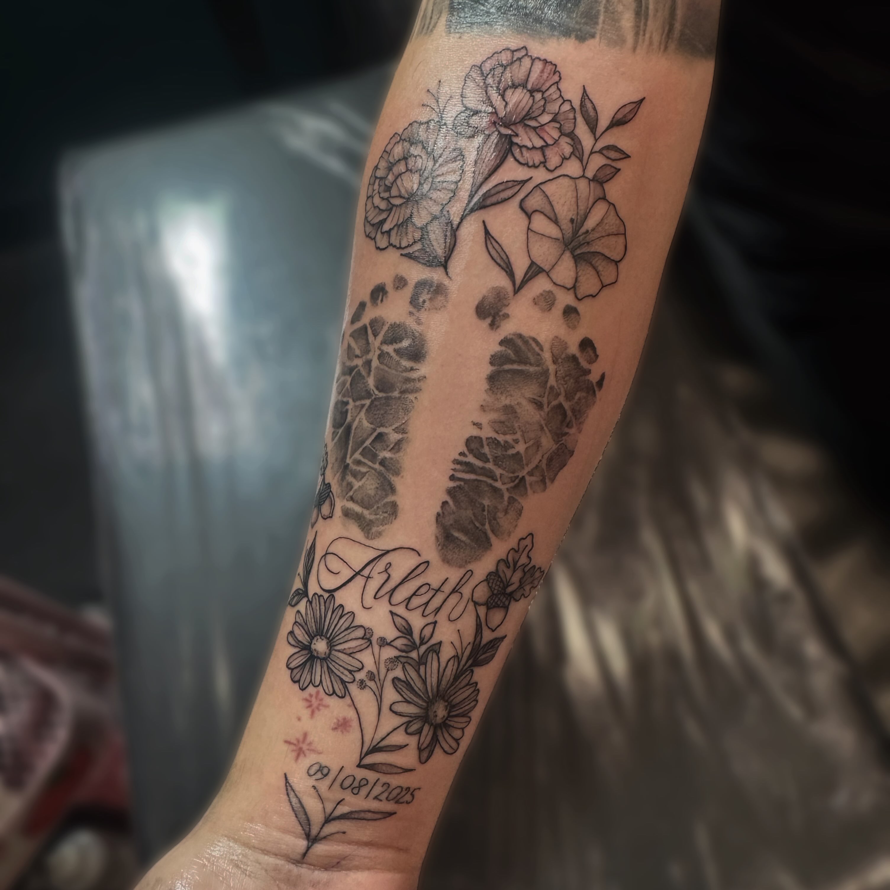 Floral arrangement black and grey tattoo on the forearm by Kelsey 🖤 Tattoo Artist, Waterford Township