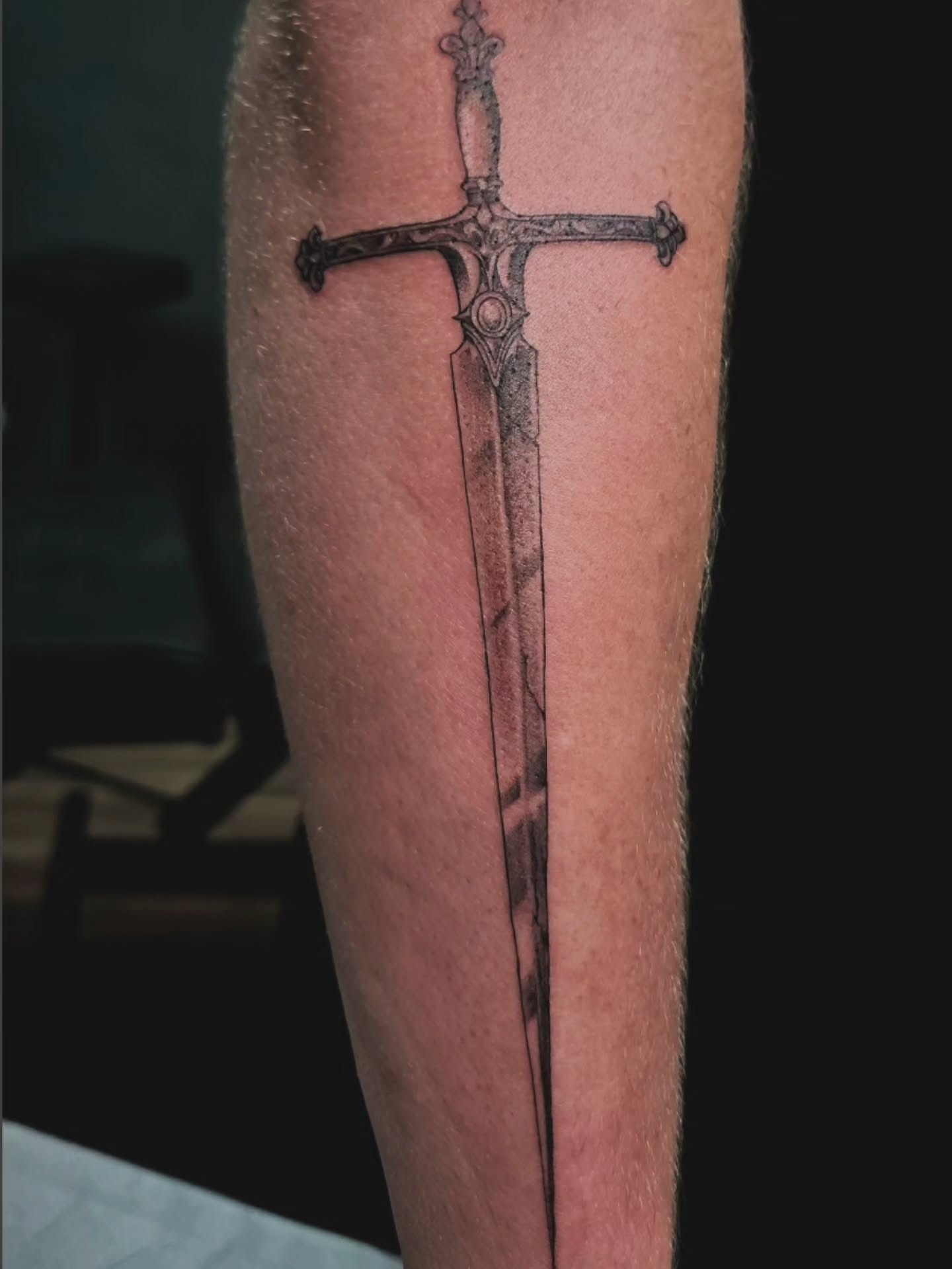 Sword black and grey tattoo on the forearm by Adriannah Esparza