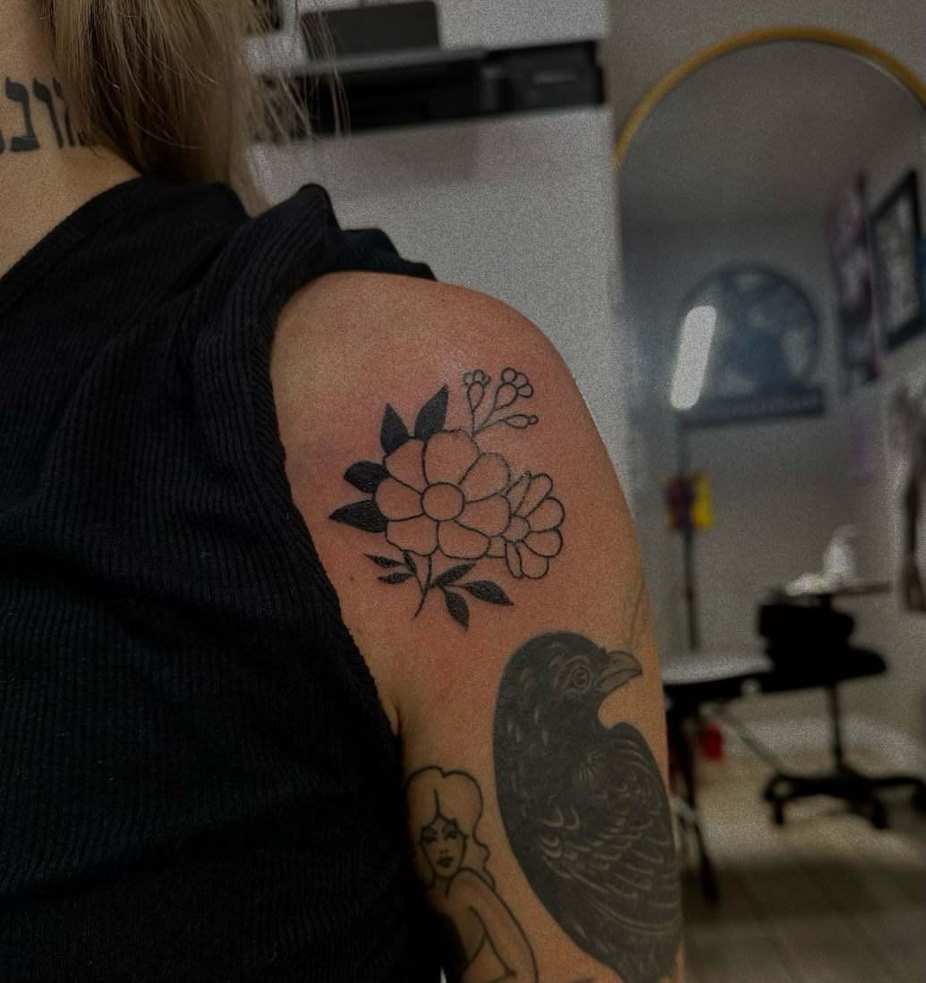 Flowers and bird black and grey tattoo on the shoulder by Marly Quinn