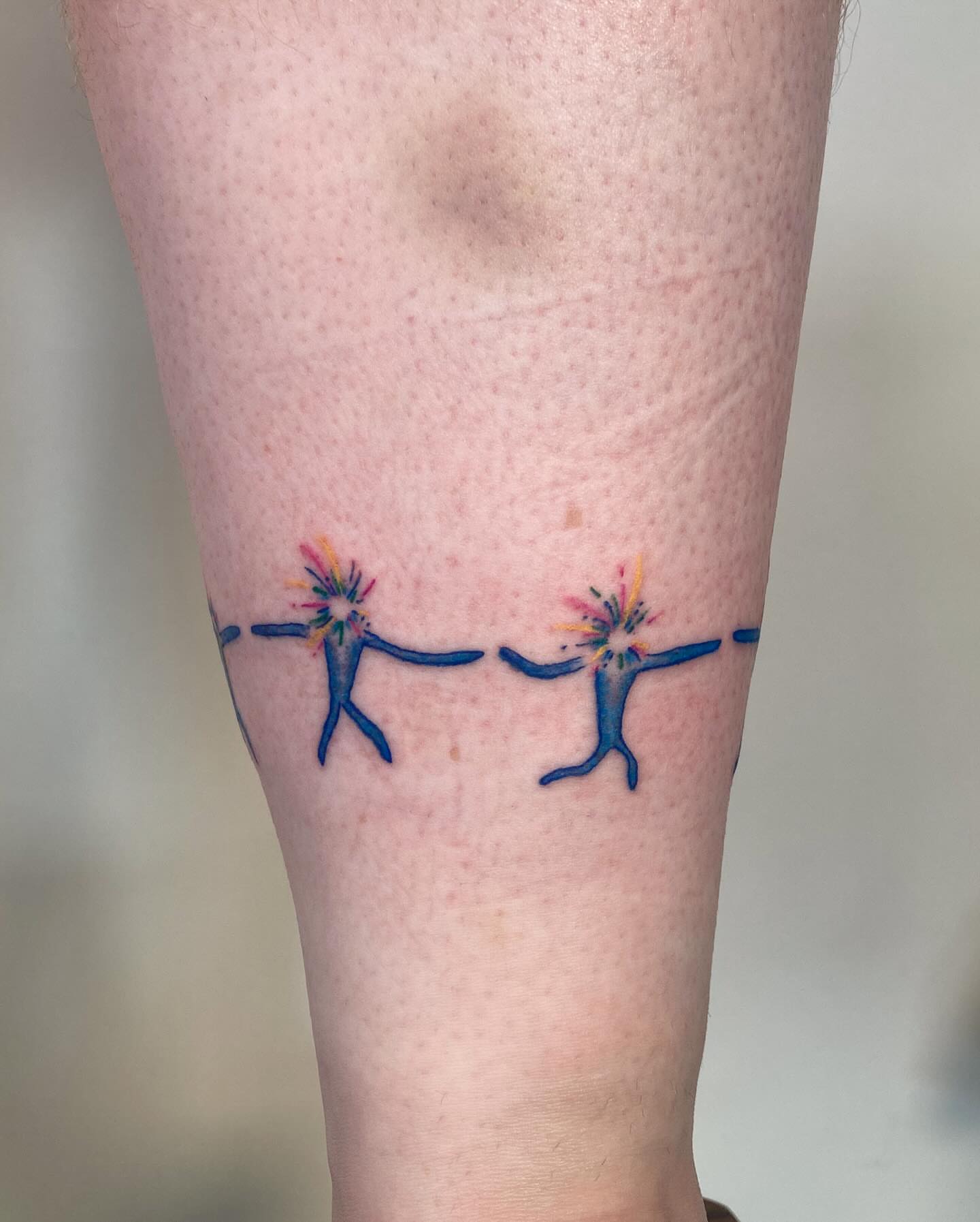 Two dancers with fireworks watercolor tattoo on the forearm by james <3