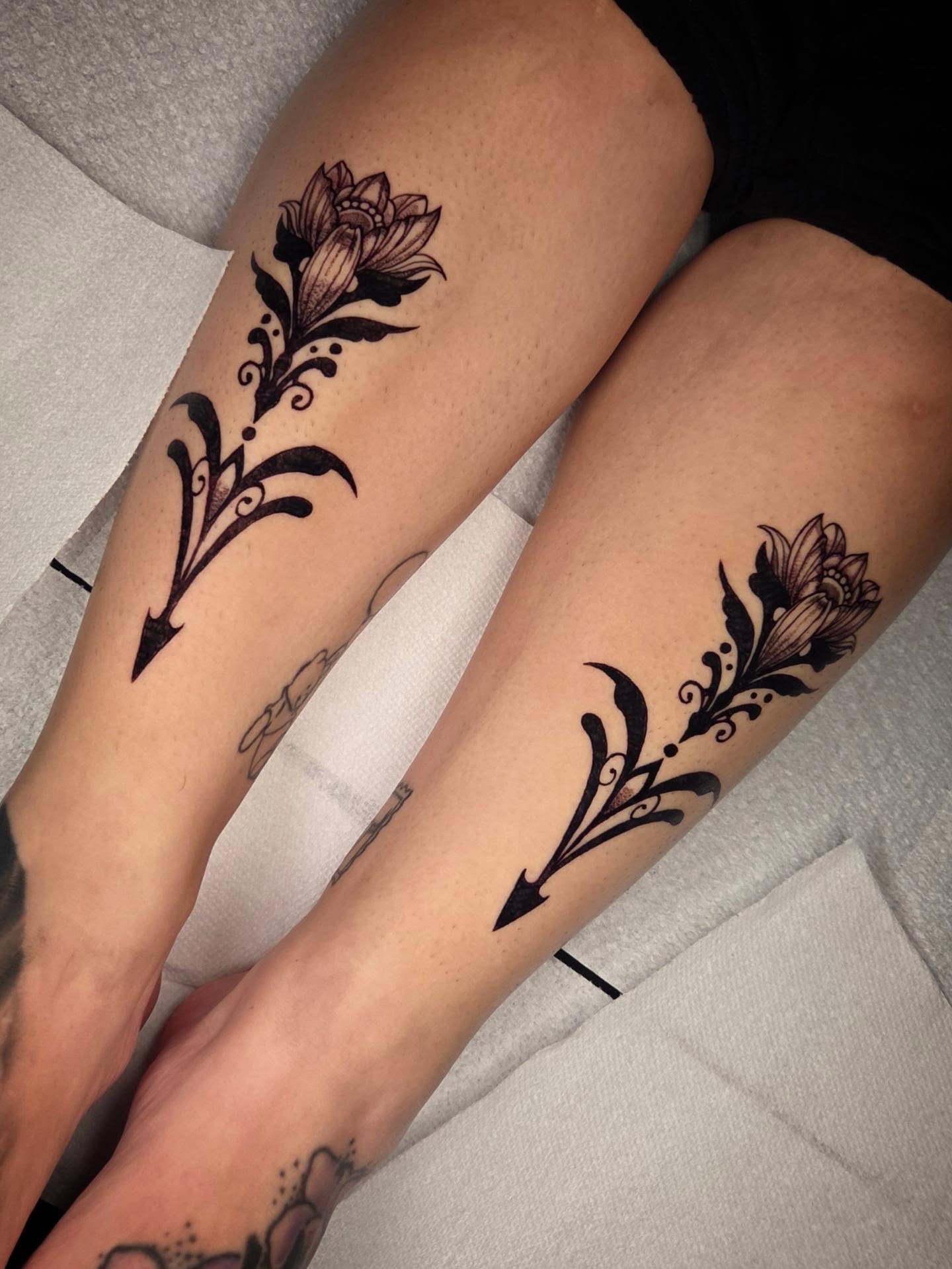 Lotus flower black and grey tattoo on the leg by Devin 🖤