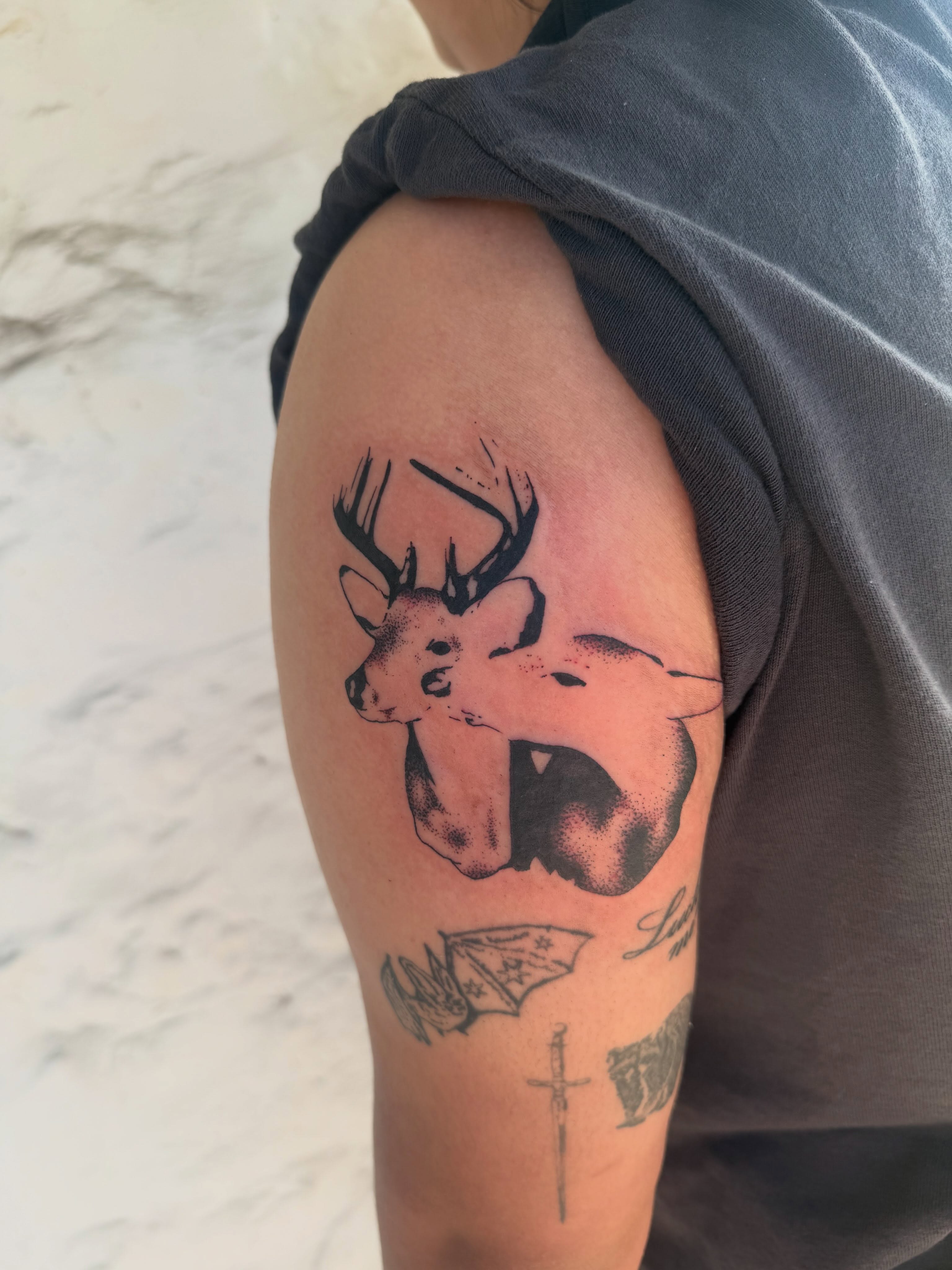 Deer black and grey tattoo on the shoulder by sarah