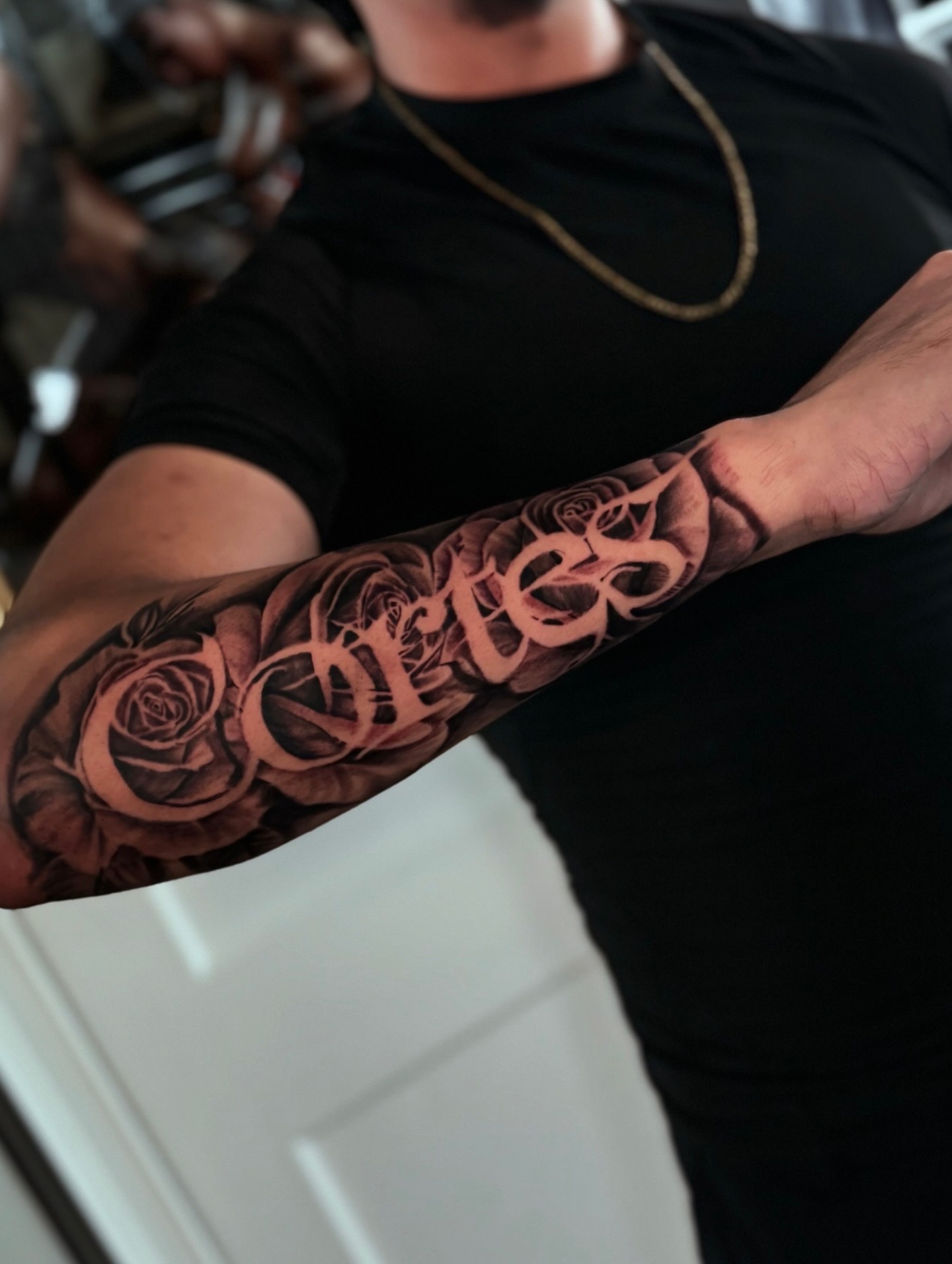 Roses and name black and grey tattoo on the forearm by Miguel Garcia