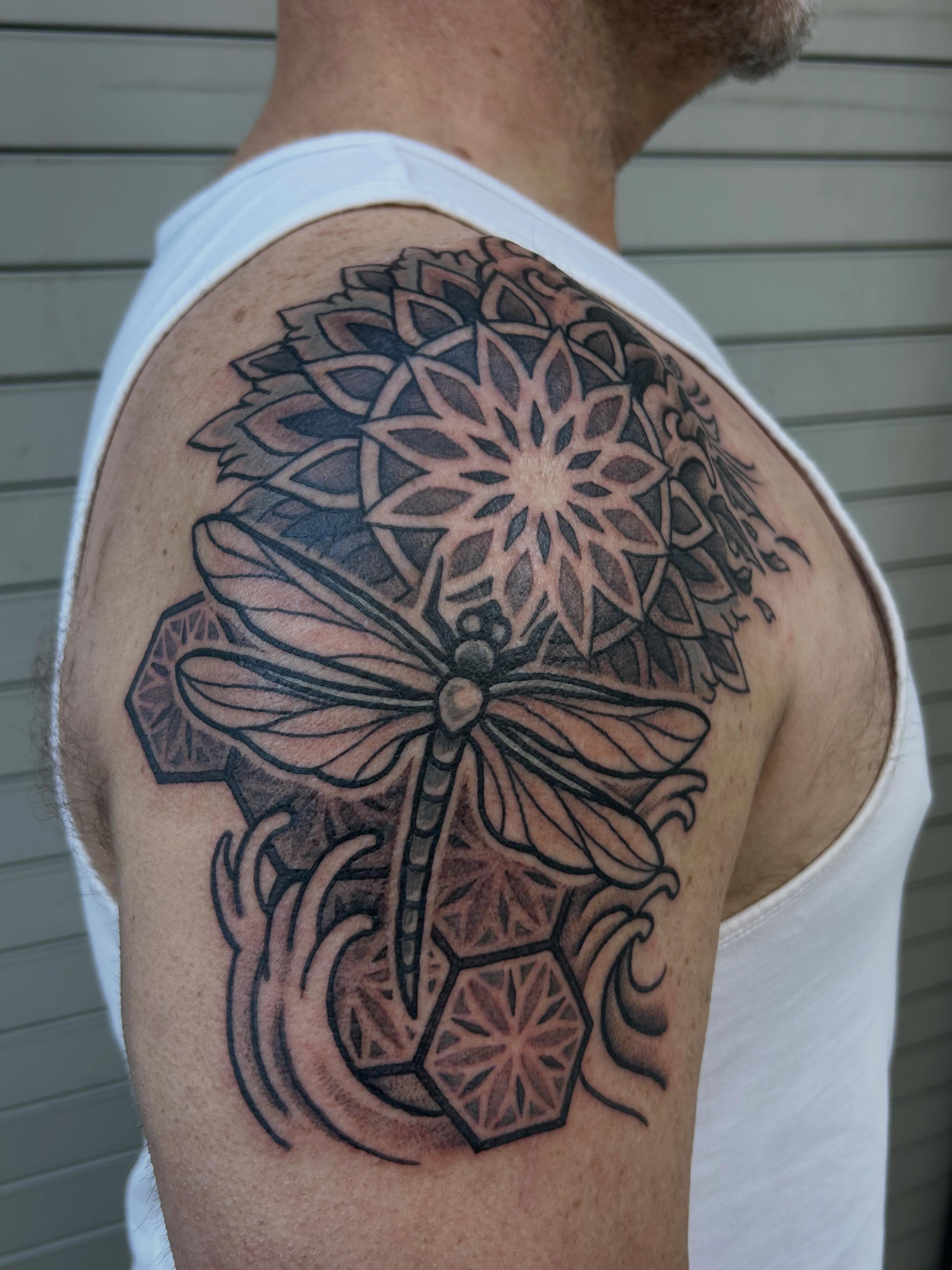 Dragonfly and mandala geometric tattoo on the shoulder by Ravi Chandra, Mount Shasta, California