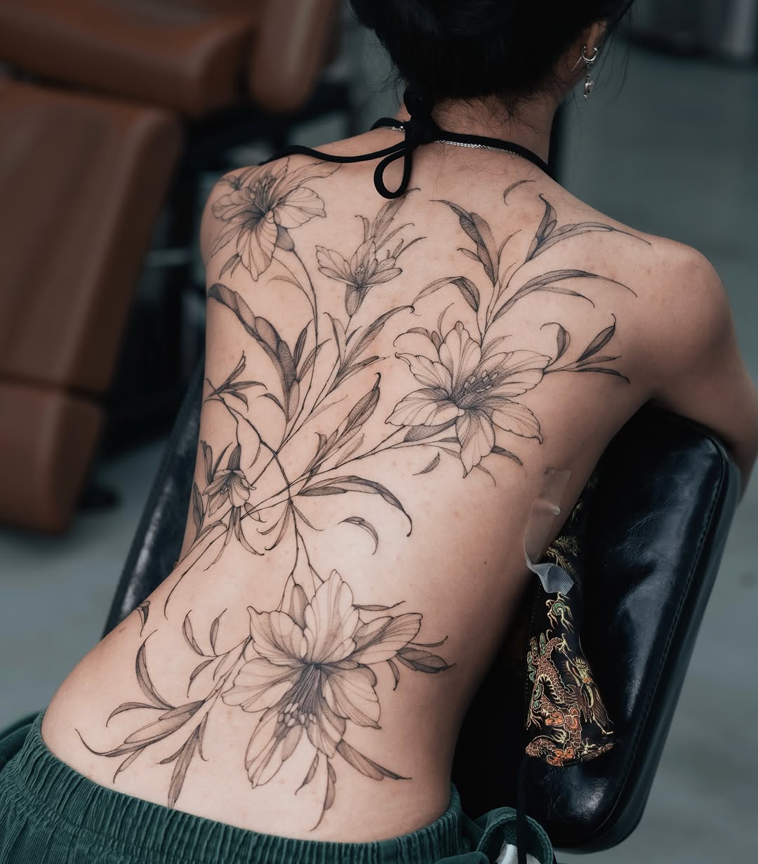 Floral arrangement black and grey tattoo on the back by Yuliia Babych tattoo AUSTIN