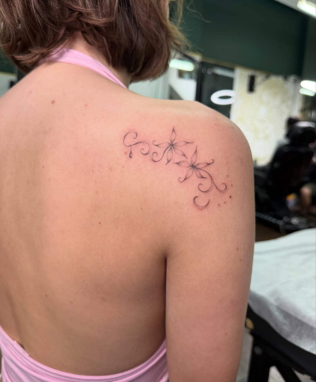 Floral design fine line tattoo on the shoulder by Soomin