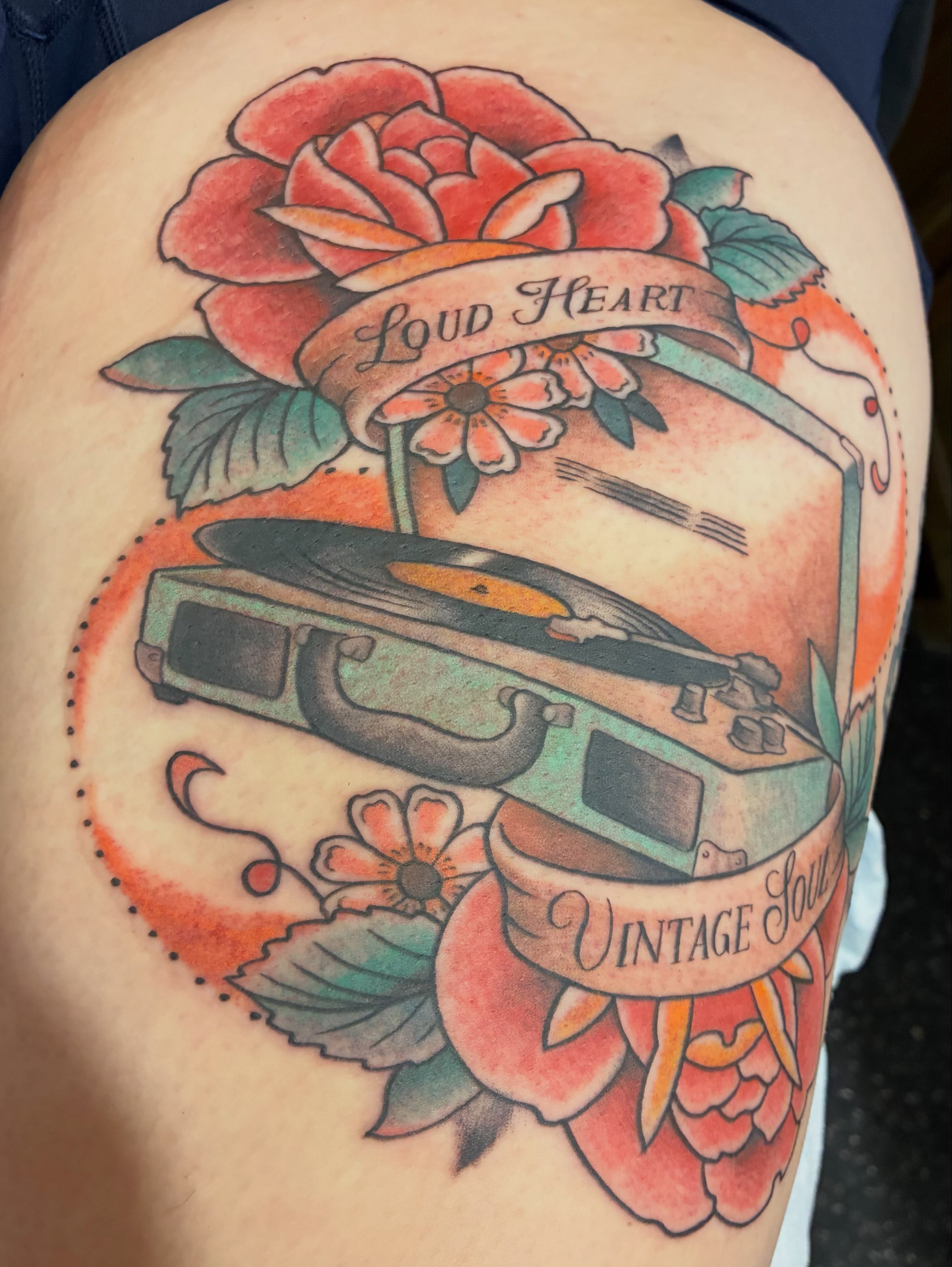 Record player and floral American traditional tattoo on the thigh by Natalie Spuhler