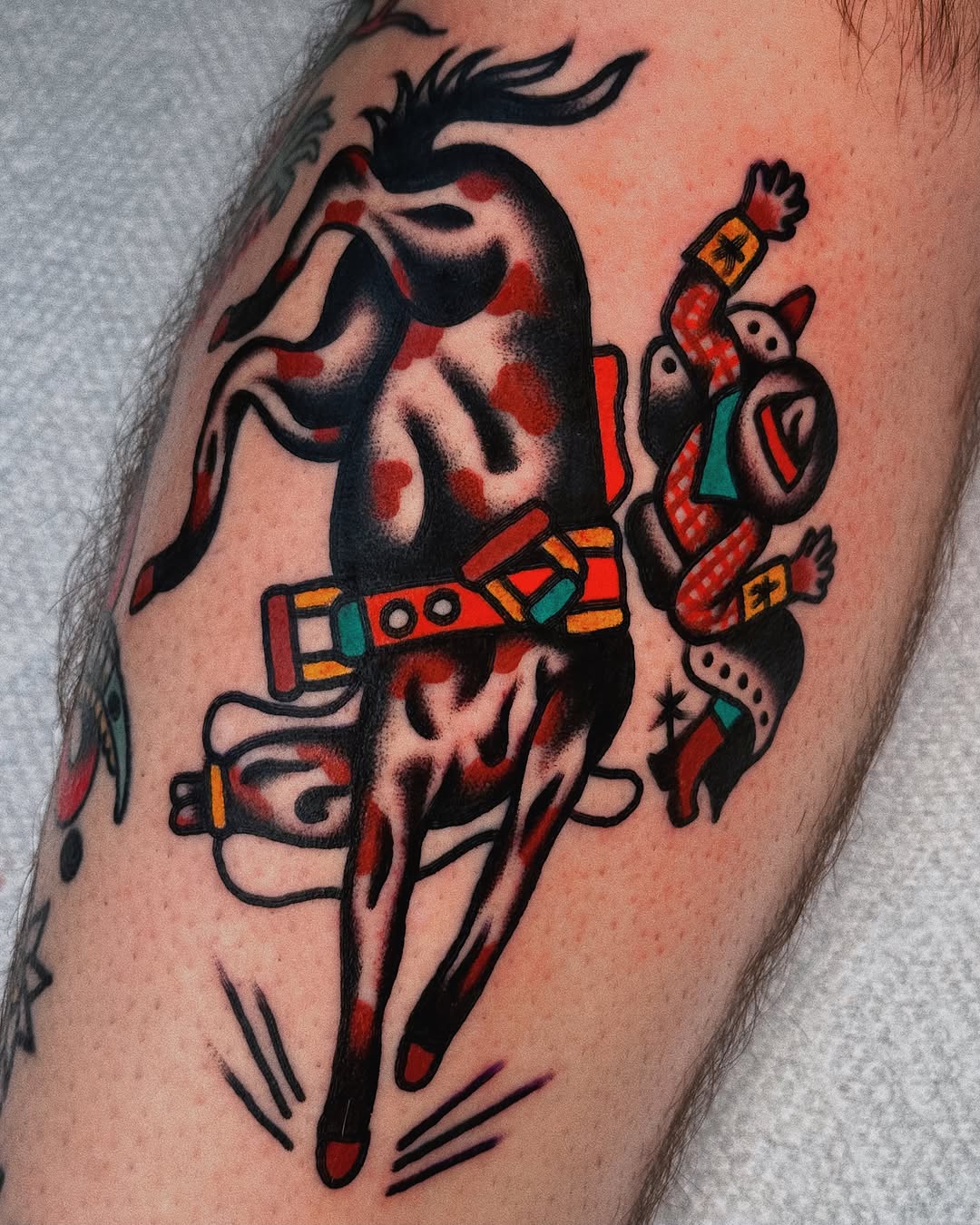 Cowboy riding horse American traditional tattoo on the upper arm by Sean Michel, Nashua, New Hampshire