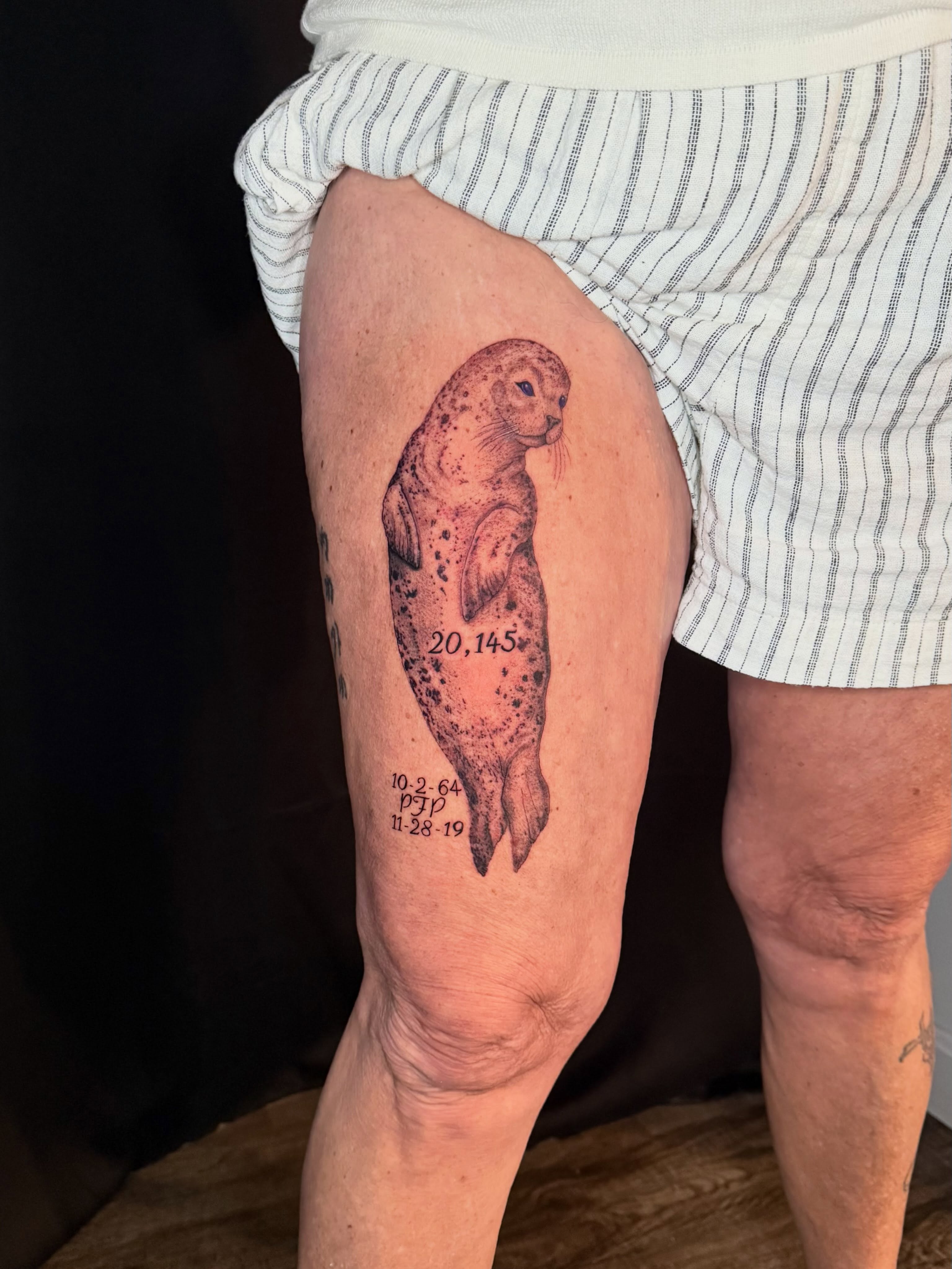 Seal realism tattoo on the thigh by Damon Moore