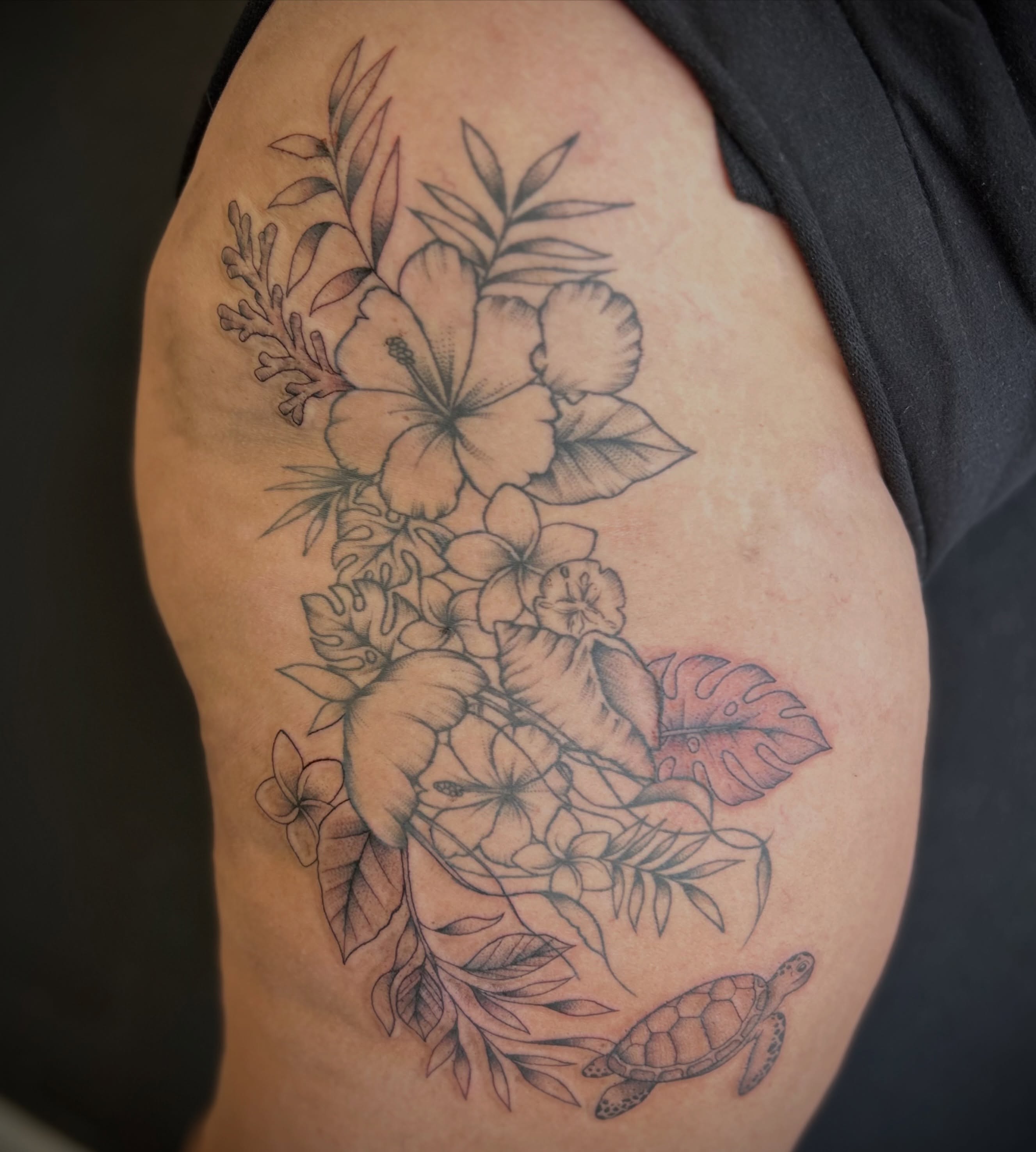 Floral arrangement with turtle black and grey tattoo on the shoulder by Browtique & Ink, Clearwater, Florida