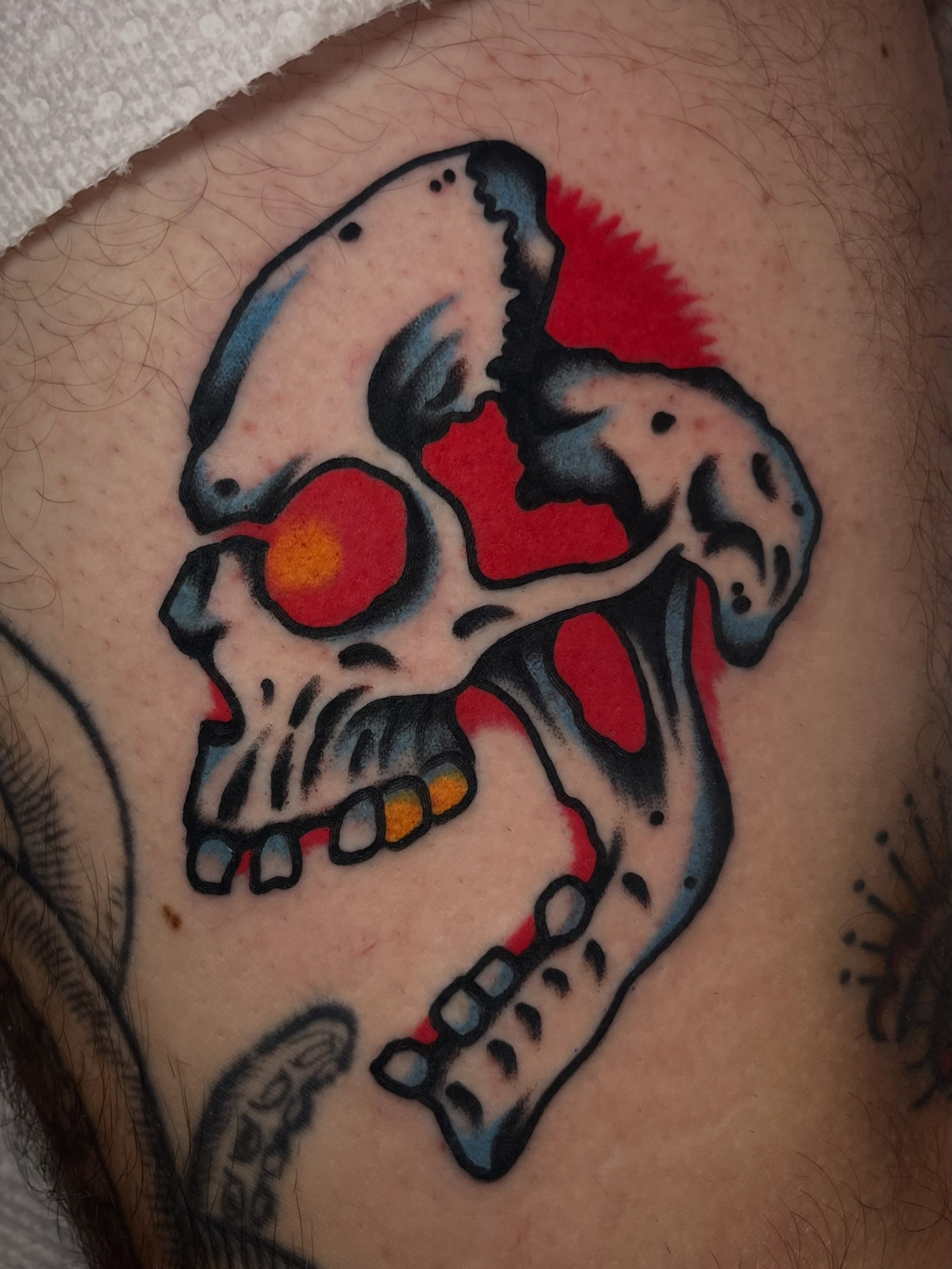 Skull American traditional tattoo on the thigh by Jake LiCausi