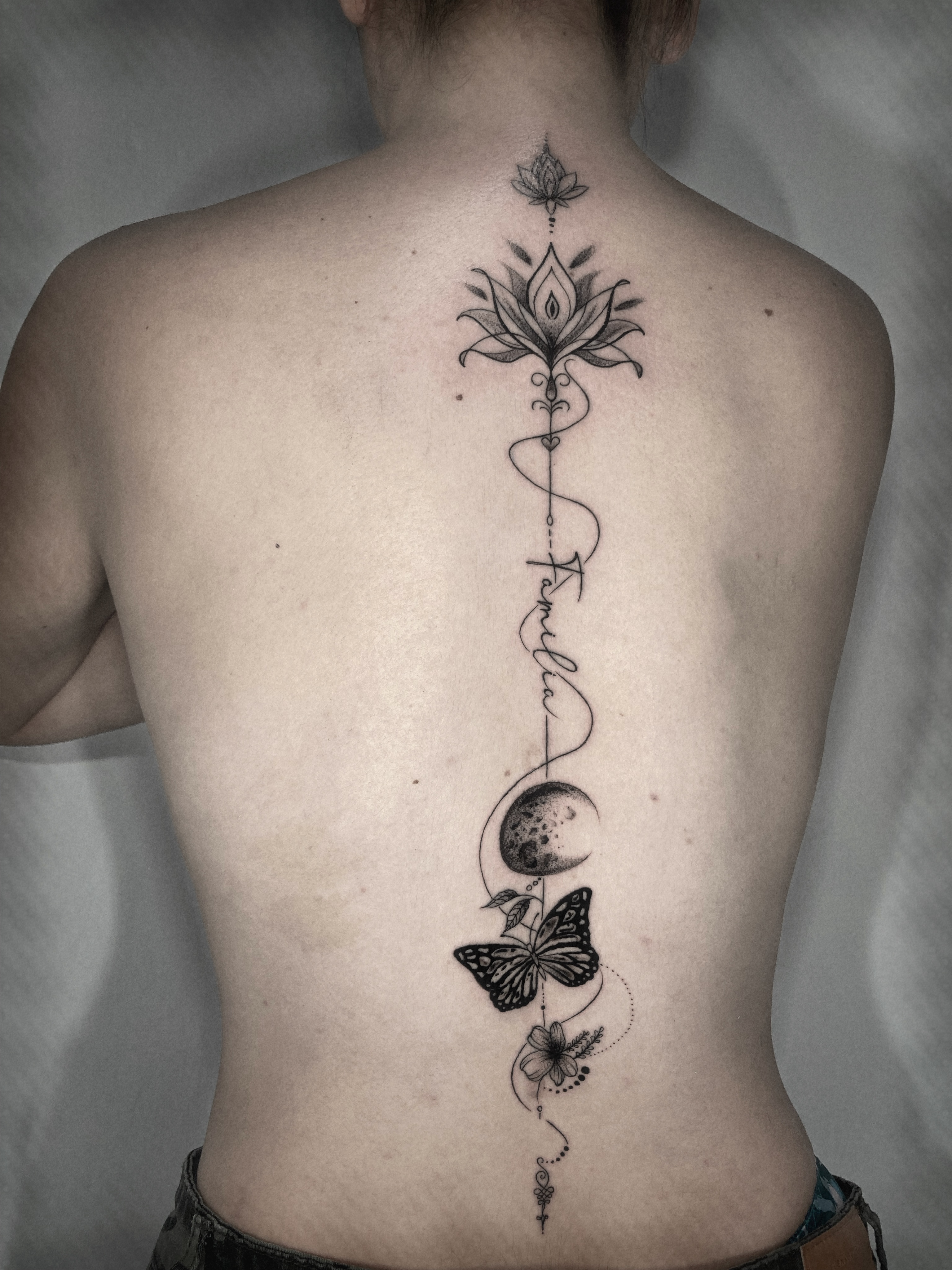 Lotus flower and celestial elements geometric tattoo on the back by Alvaro