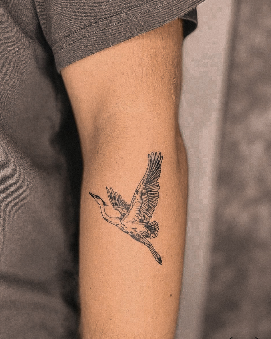 Bird in flight black and grey tattoo on the forearm by Richmond tattoo shop, Richmond, Texas