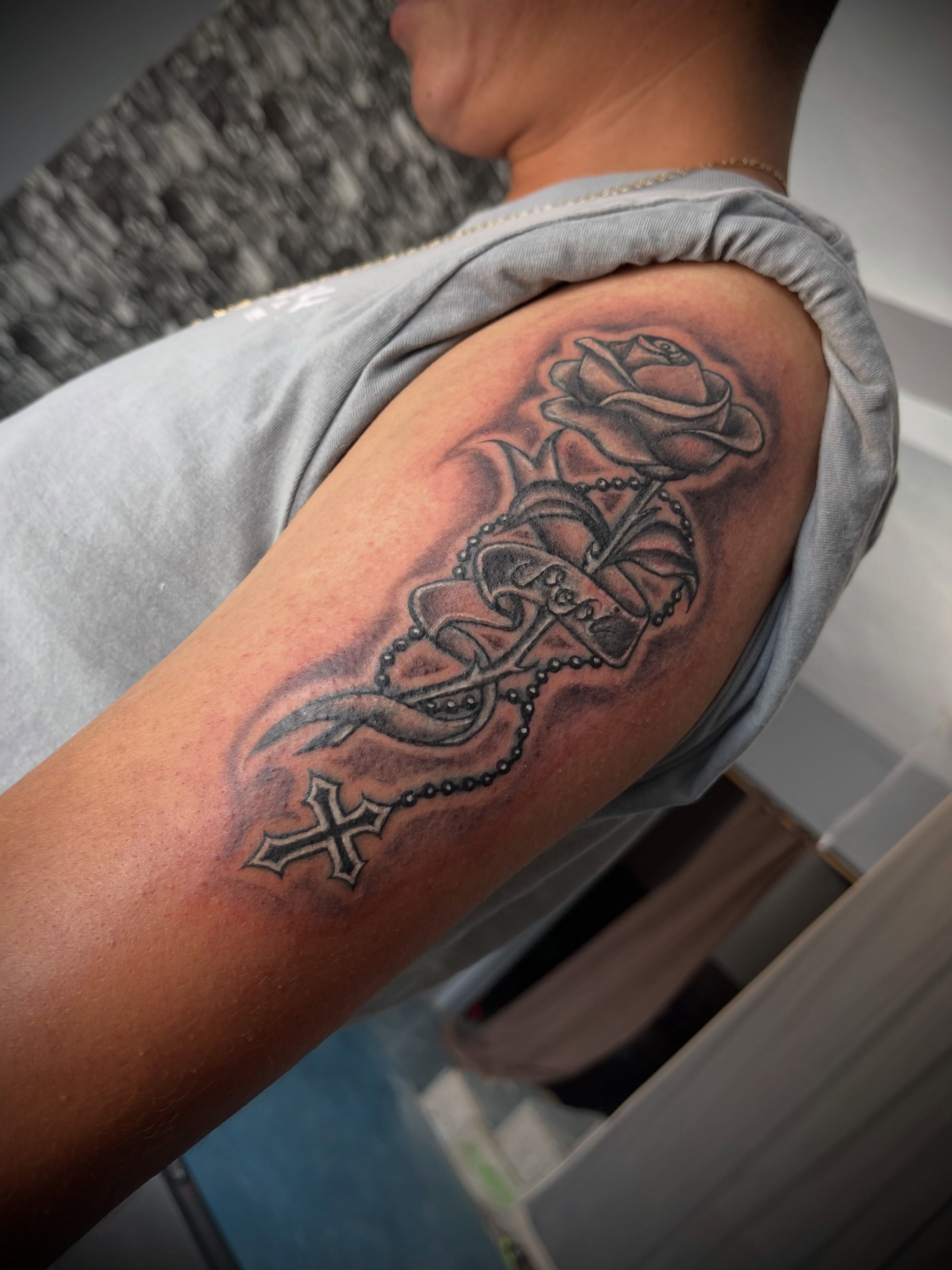 Cross and rose black and grey tattoo on the forearm by Tu SanchoTattoos