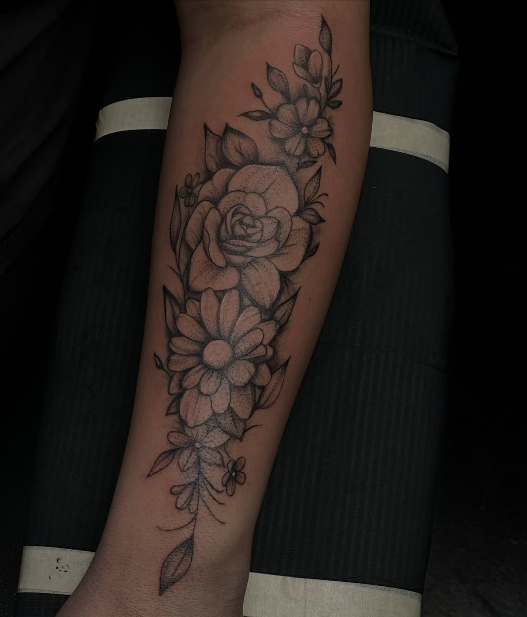 Floral arrangement dotwork tattoo on the forearm by Marly Quinn