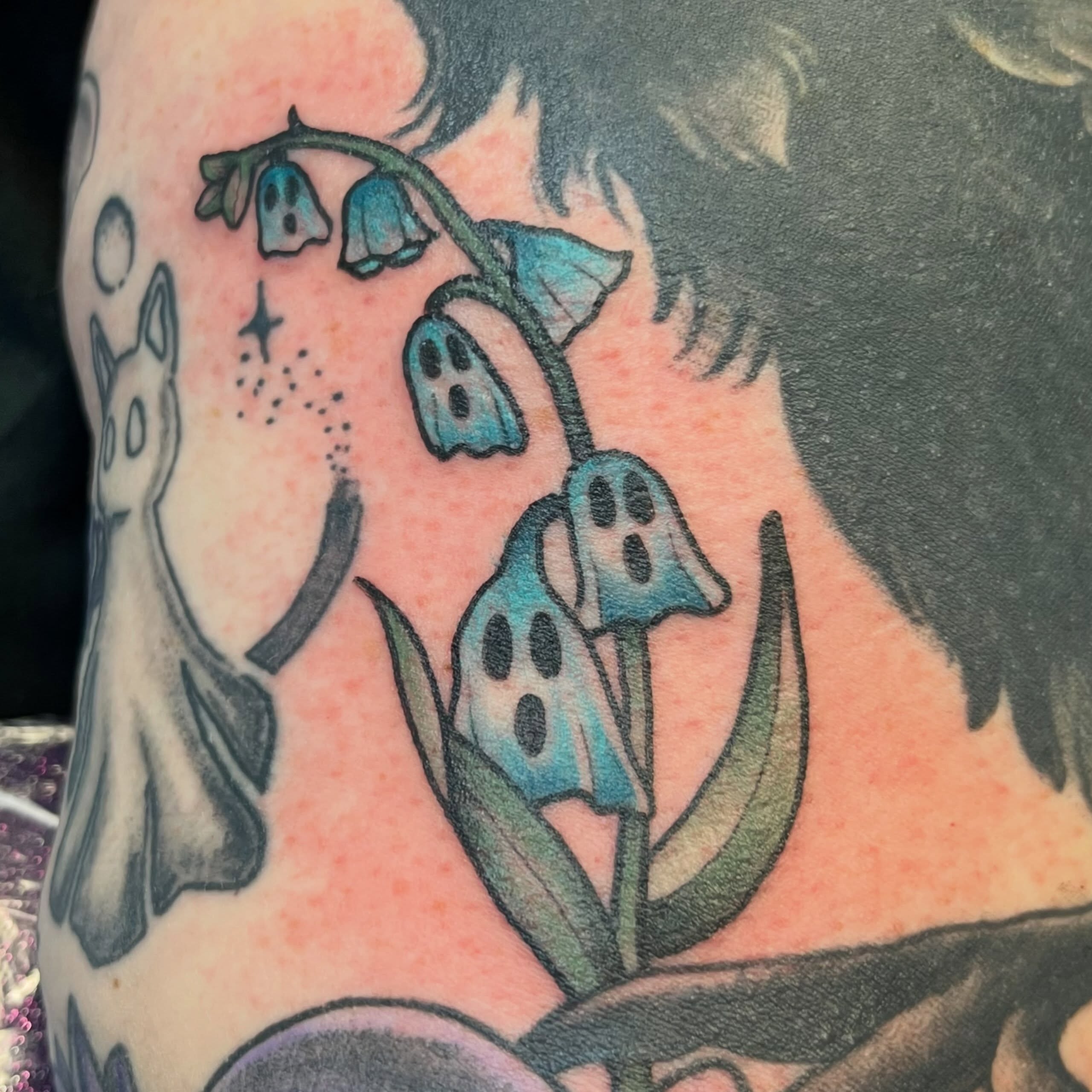 Bell flowers trash polka tattoo on the upper arm by Danielle Lorandeau