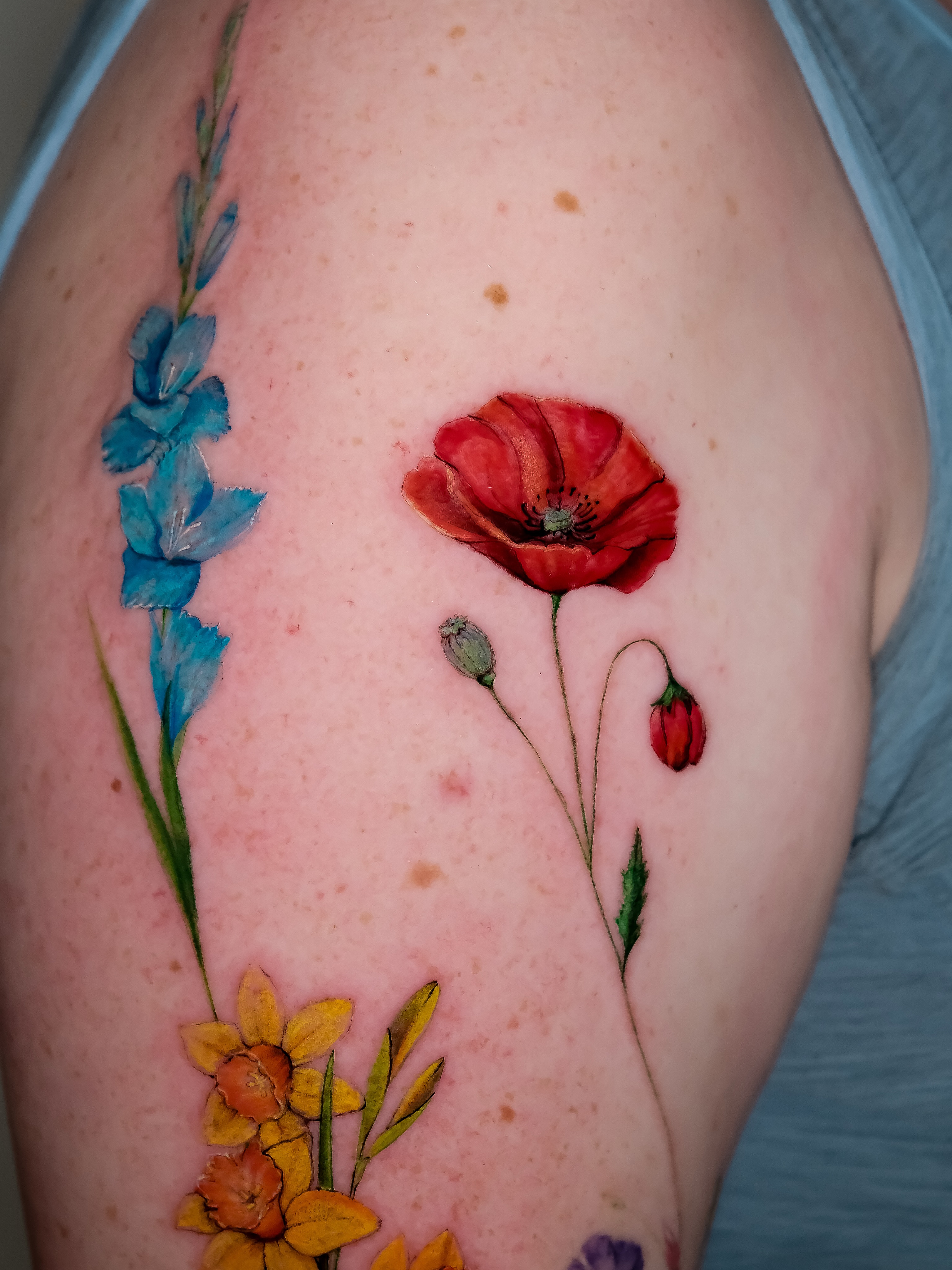 Floral arrangement realism tattoo on the shoulder by NAS