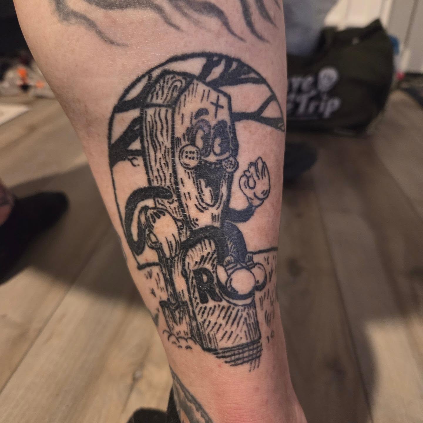 Skateboarder black and grey tattoo on the forearm by Mary