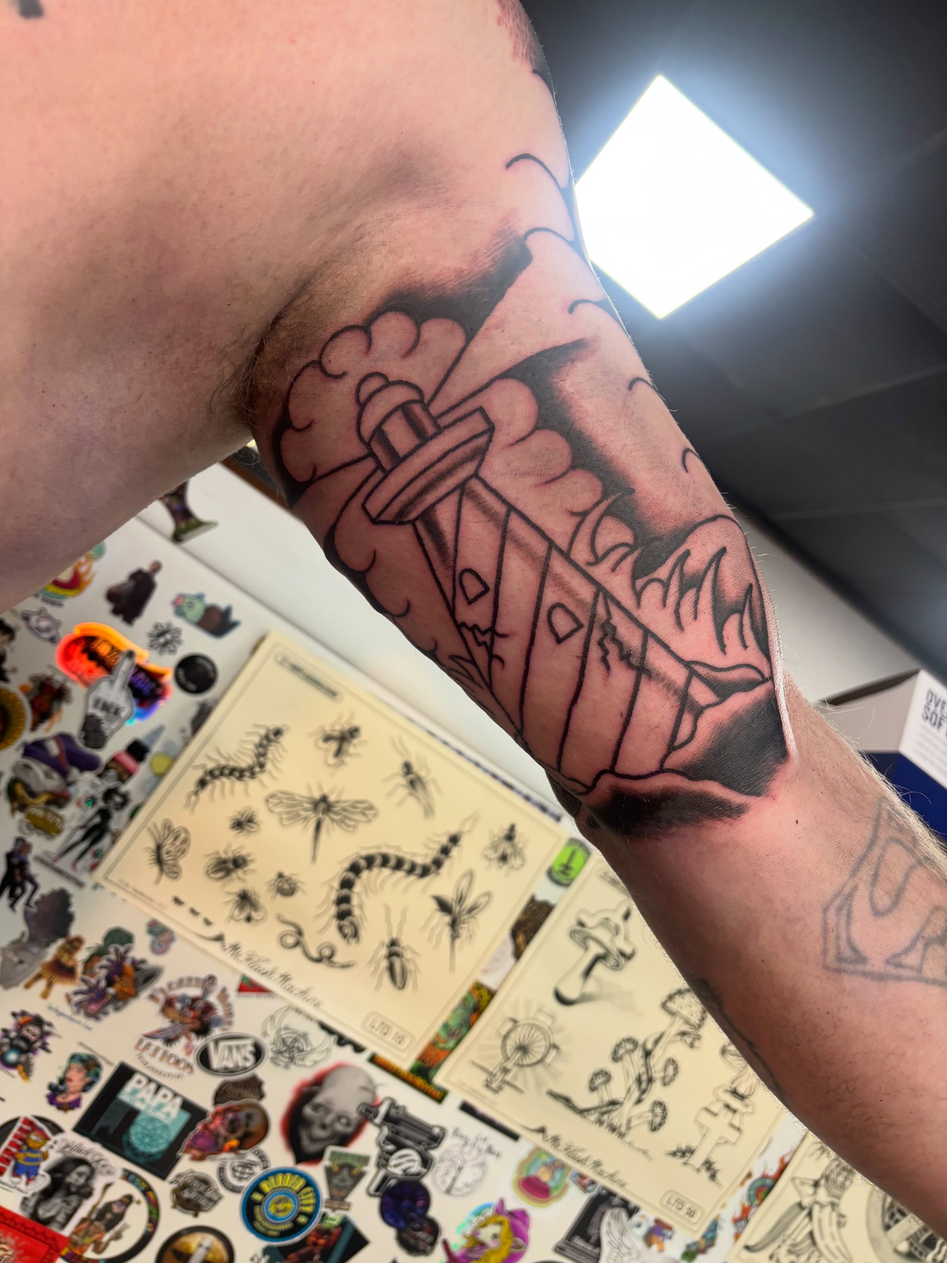 Hammer and flame black and grey tattoo on the forearm by Bold Will Hold ๐ค