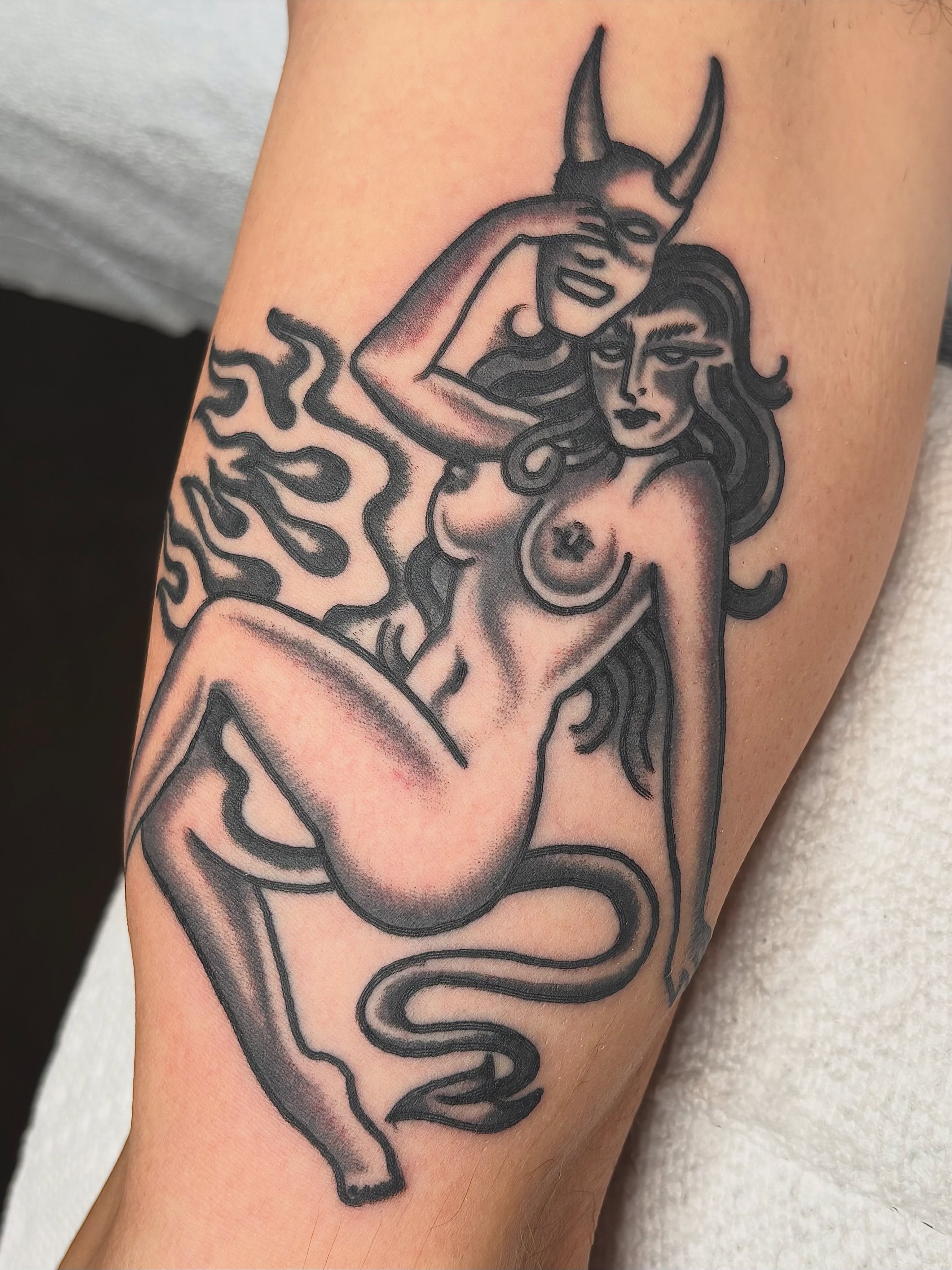 Naked woman with horns American traditional tattoo on the forearm by ๐๐๐ฏ๐ข๐ซ