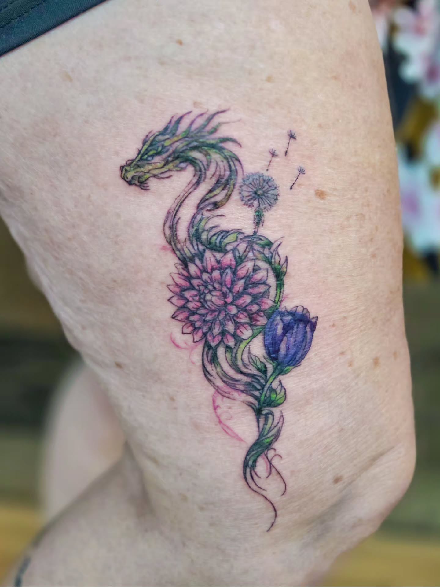 Dragon and flowers watercolor tattoo on the thigh by Courtney, Lakewood, Ohio