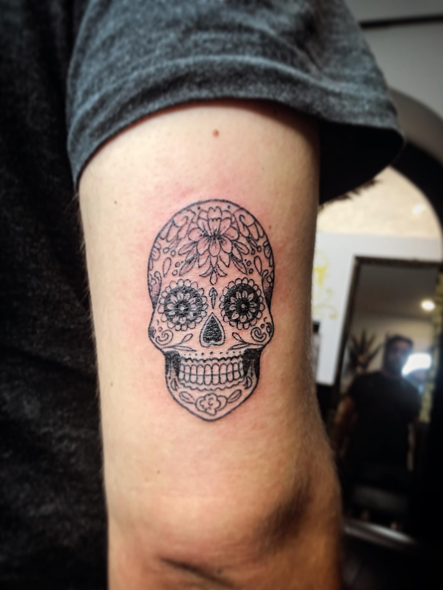Sugar skull black and grey tattoo on the forearm by Moss Quito Tattoo