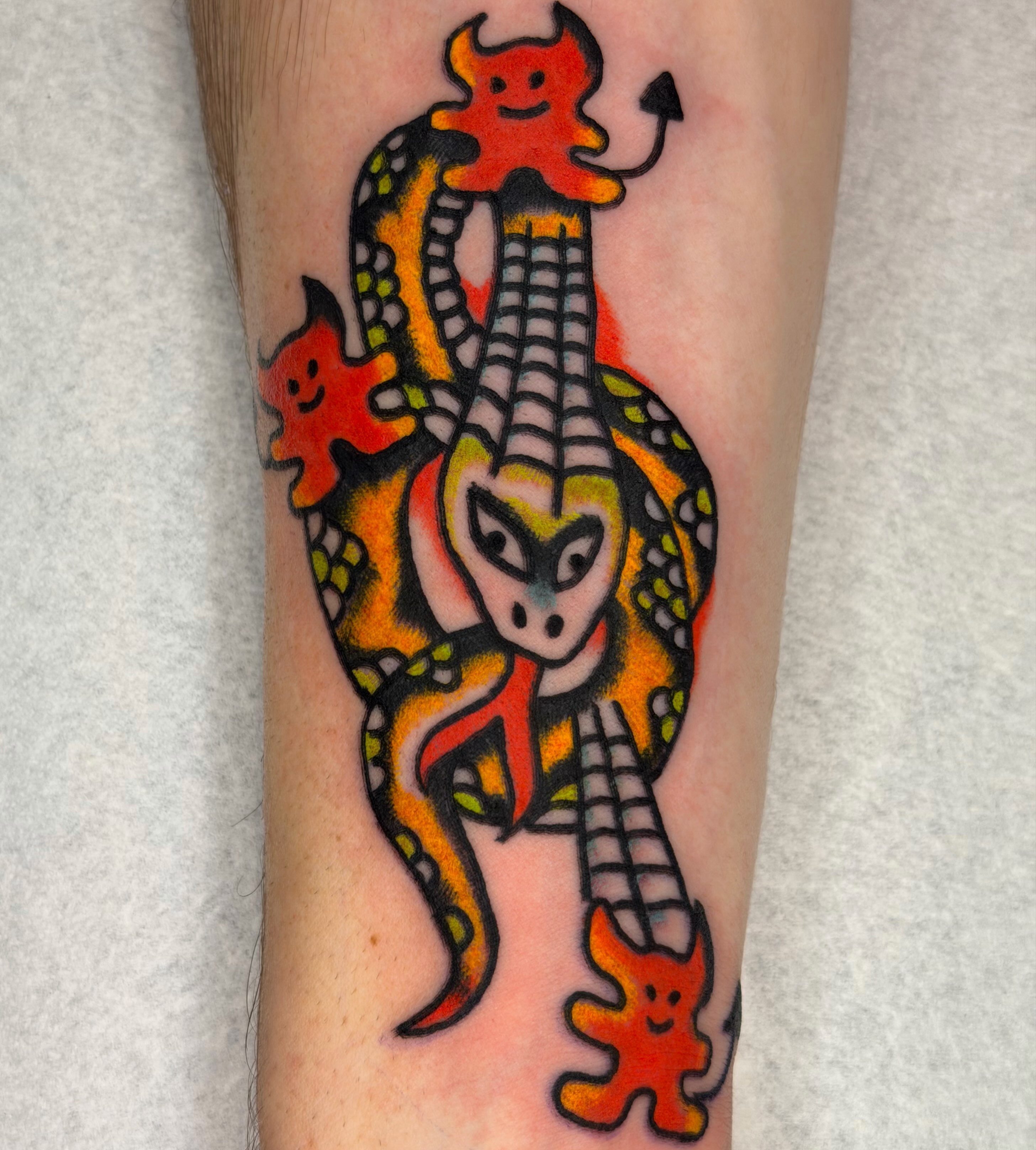 Demon and snake American traditional tattoo on the forearm by Jake
