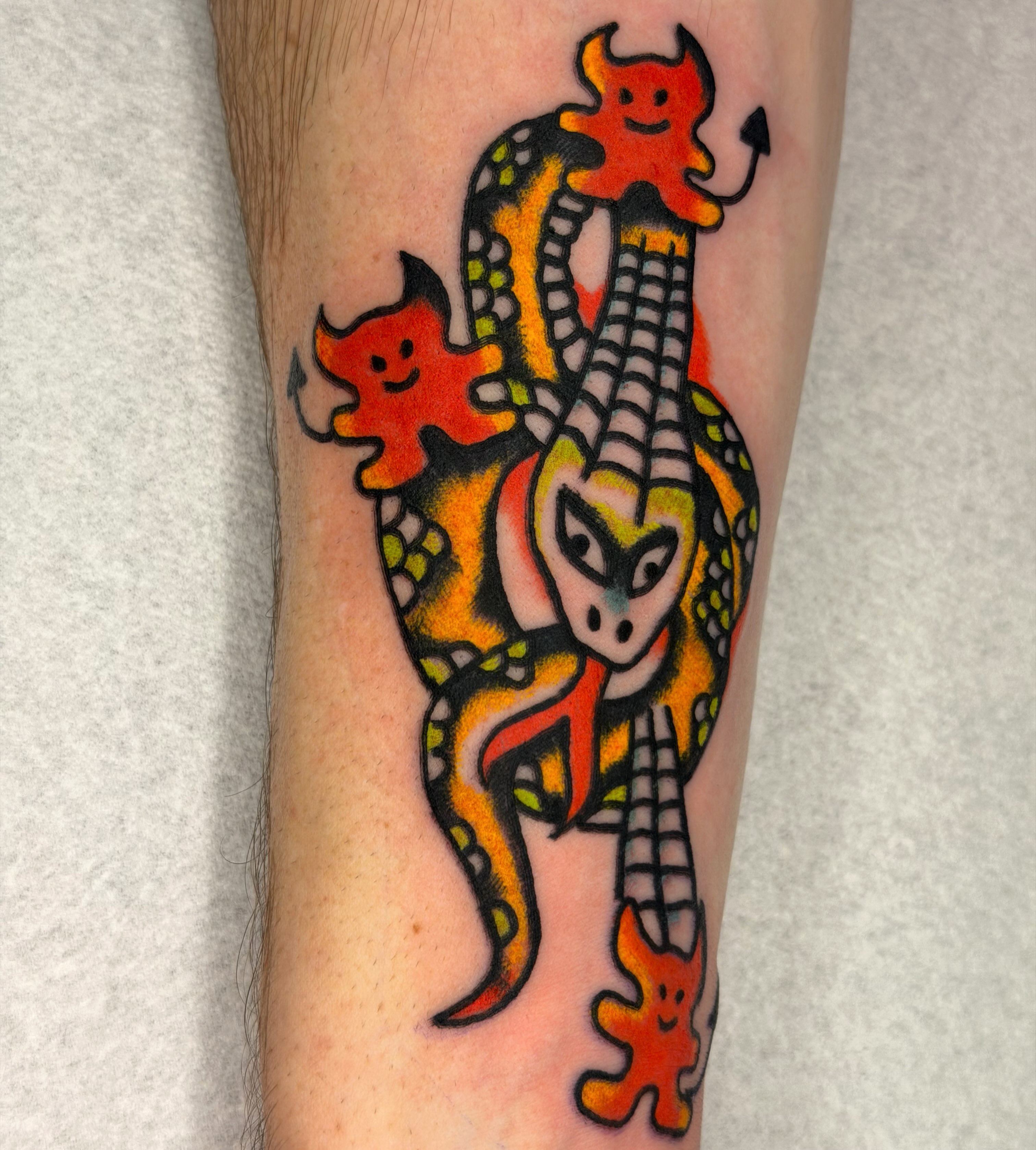 Serpent with devil horns American traditional tattoo on the forearm by Jake
