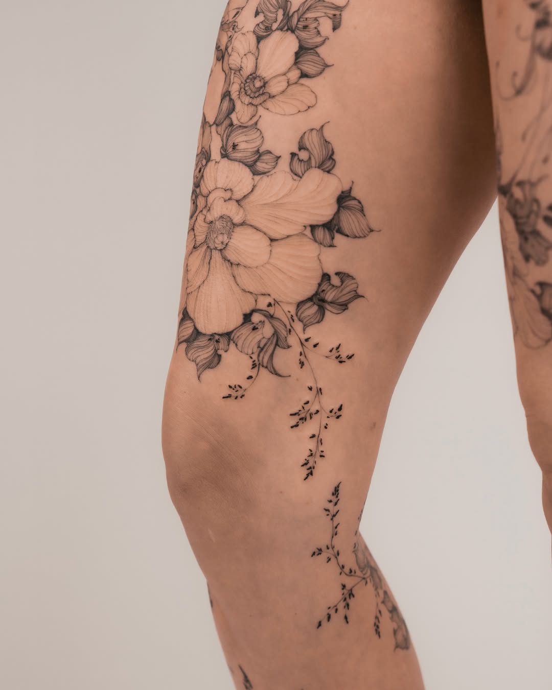 Floral bouquet black and grey tattoo on the leg by Marek