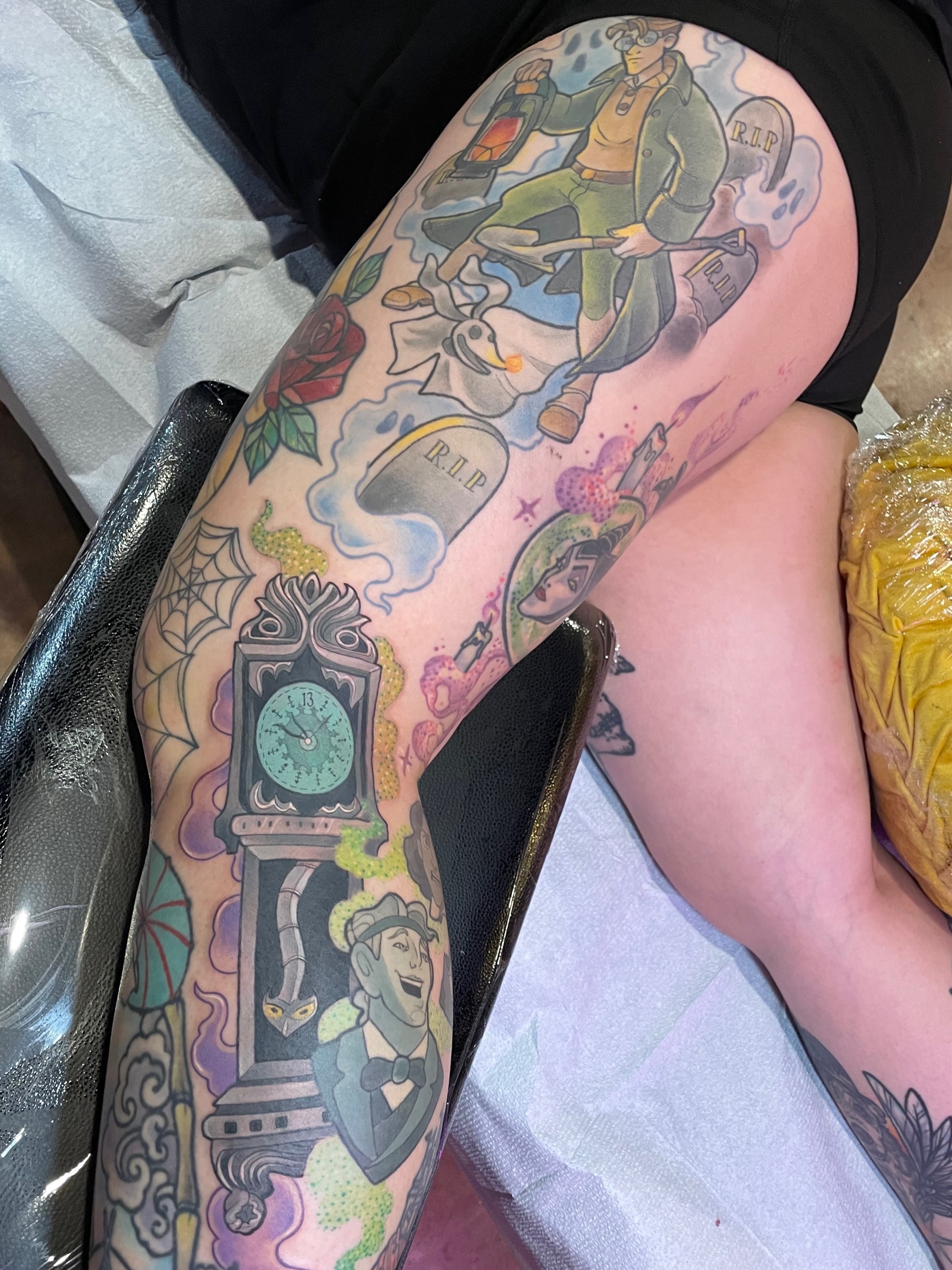 Clock tower and characters American traditional tattoo on the thigh by Tanya Murski