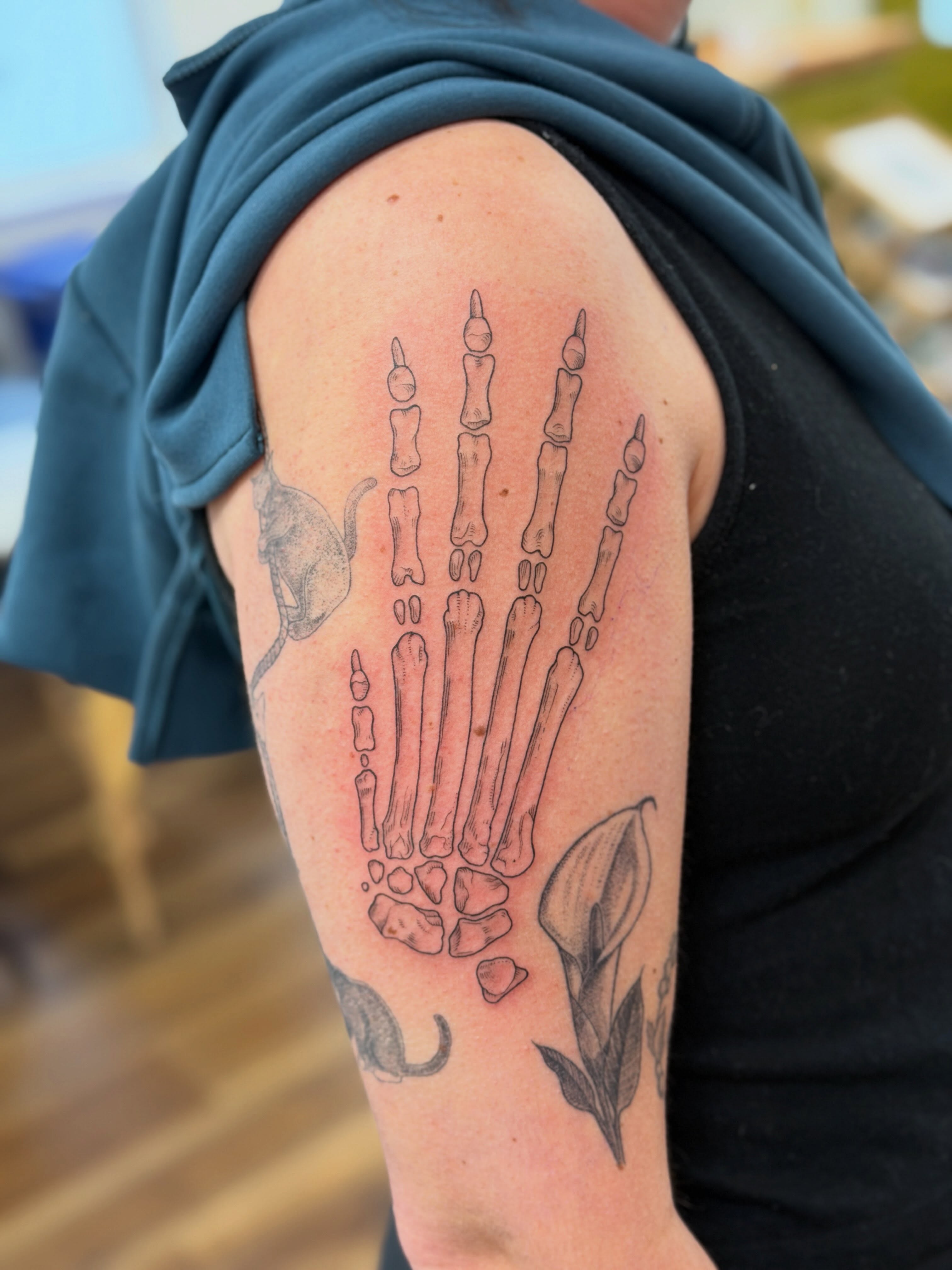 Bone handprint black and grey tattoo on the forearm by Alison (Wise) Best