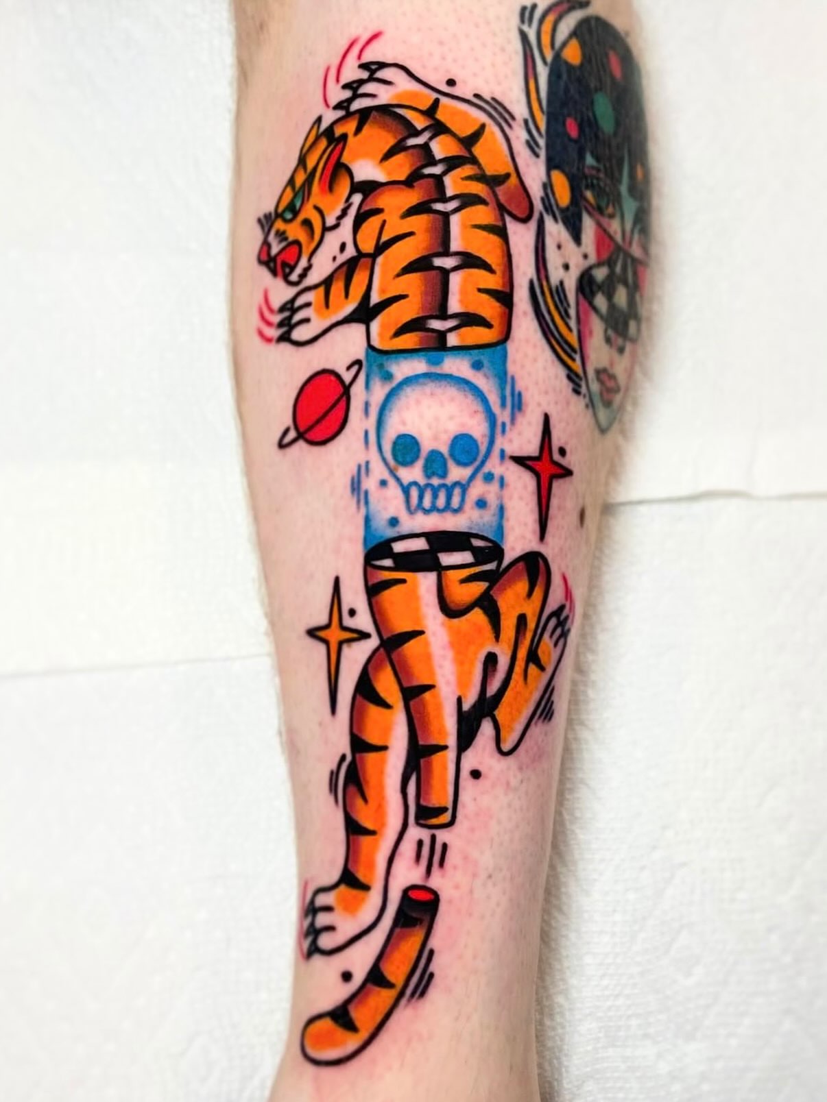 Tiger and skull American traditional tattoo on the forearm by Jacob, Marion, Illinois