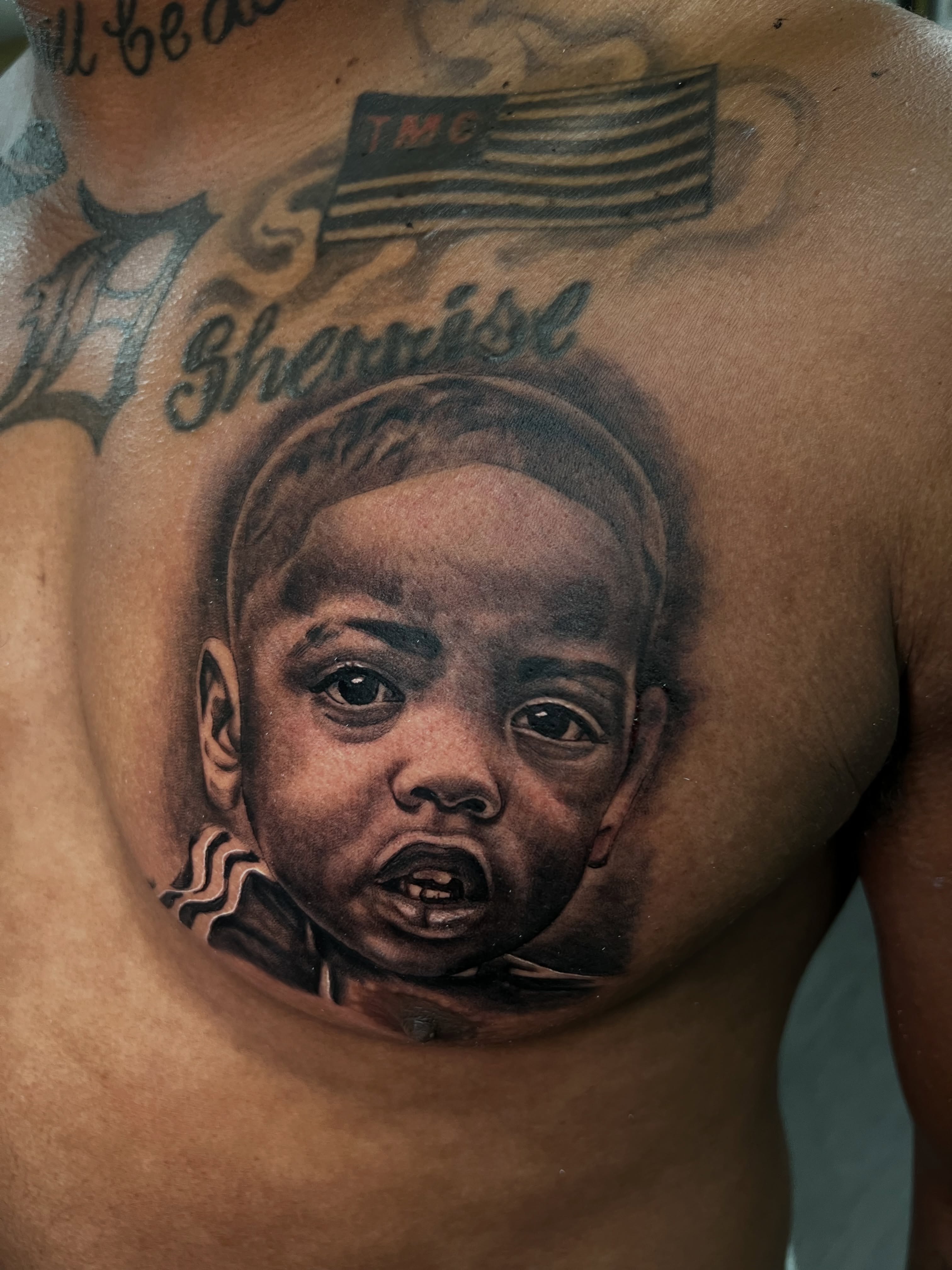 Child's face realism tattoo on the chest by Vondrae