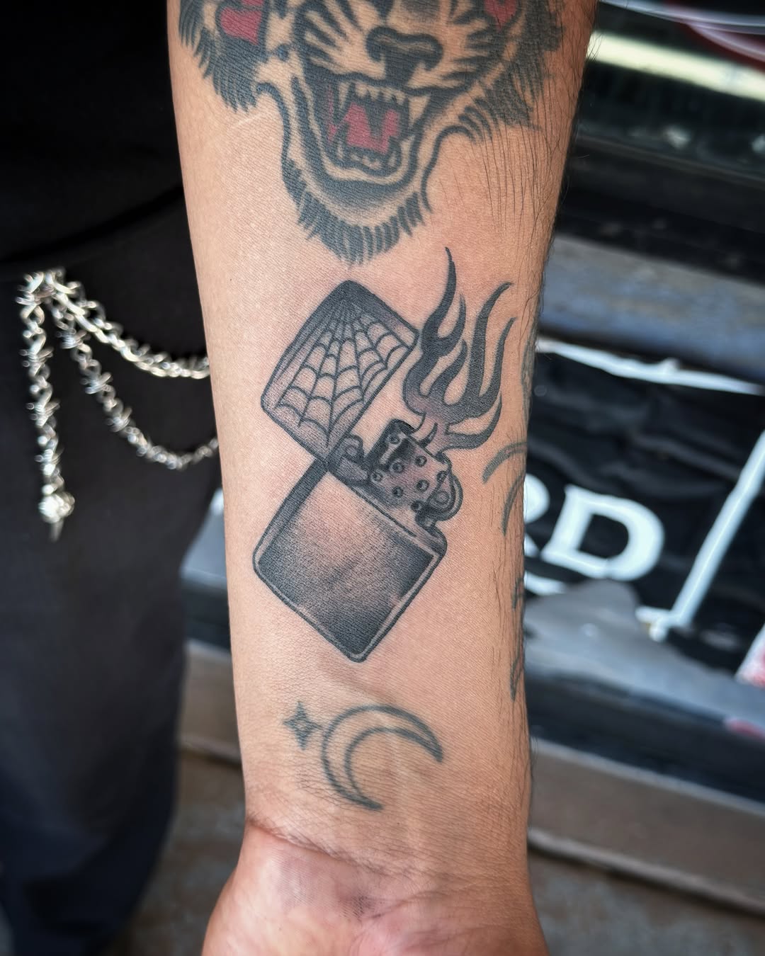 Lighter with flames black and grey tattoo on the forearm by @sloanxkettering