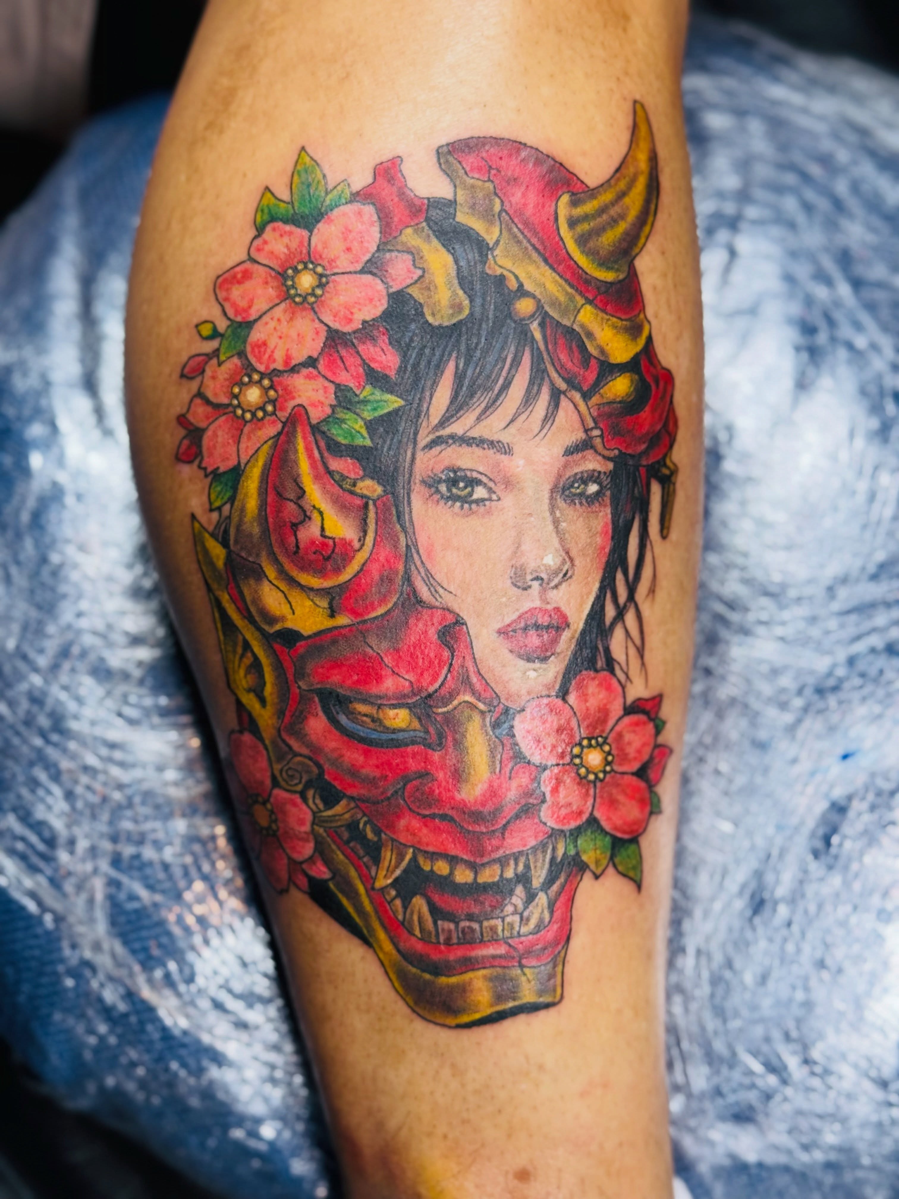 Woman with demon mask japanese irezumi tattoo on the forearm by Ink Napawong