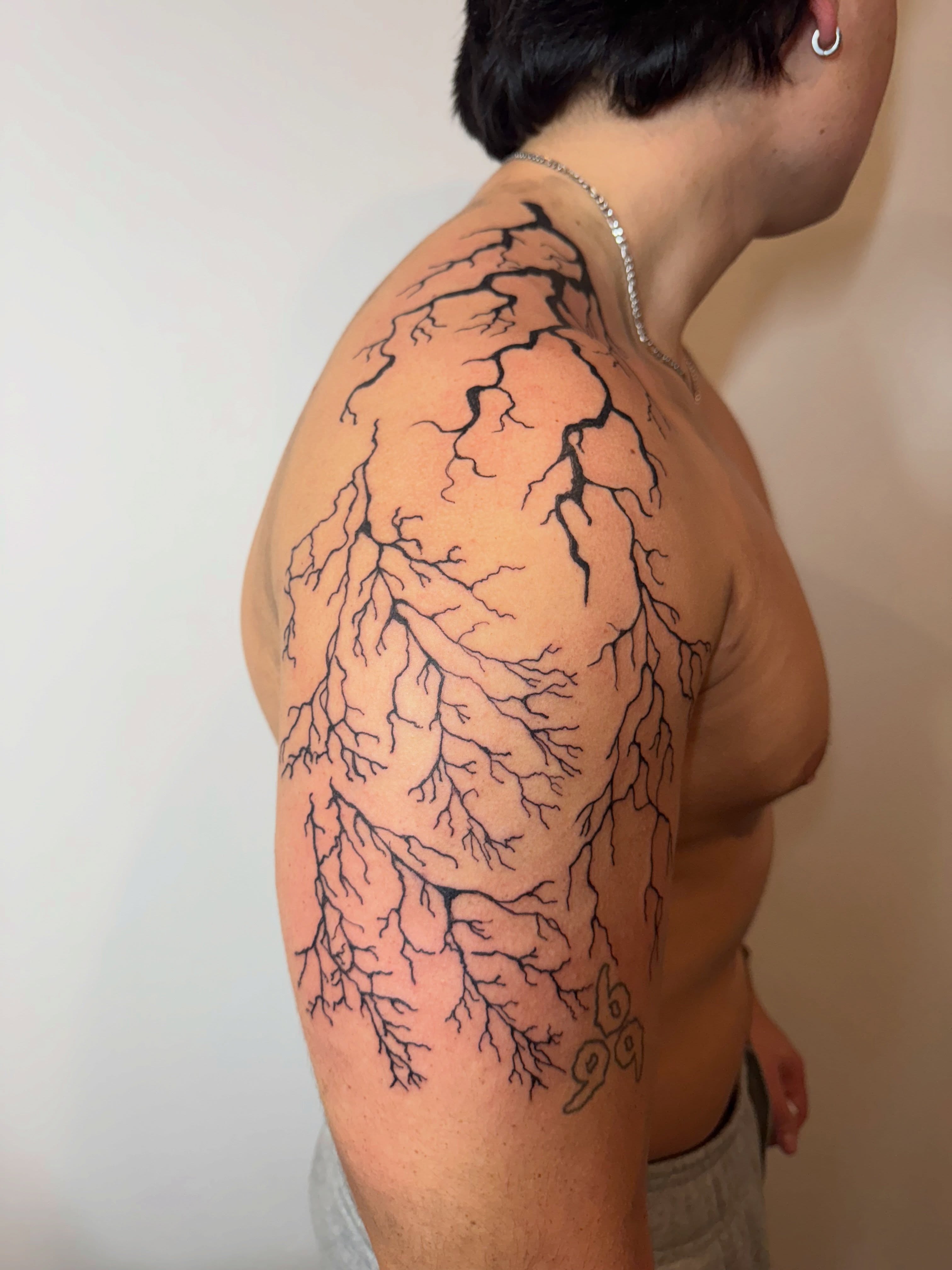 Root system black and grey tattoo on the shoulder by Ink Napawong