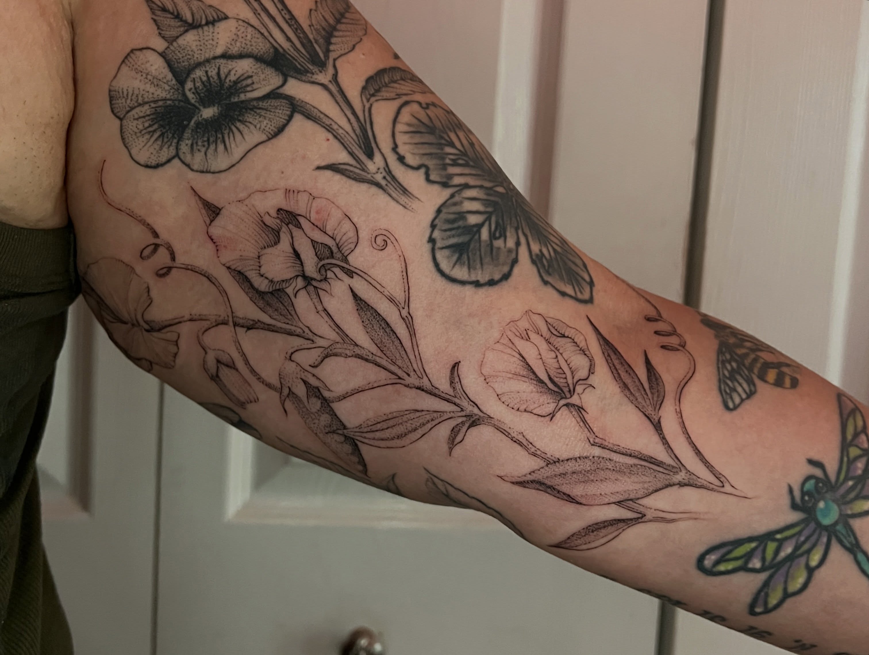 Botanical flowers realism tattoo on the forearm by Natasha