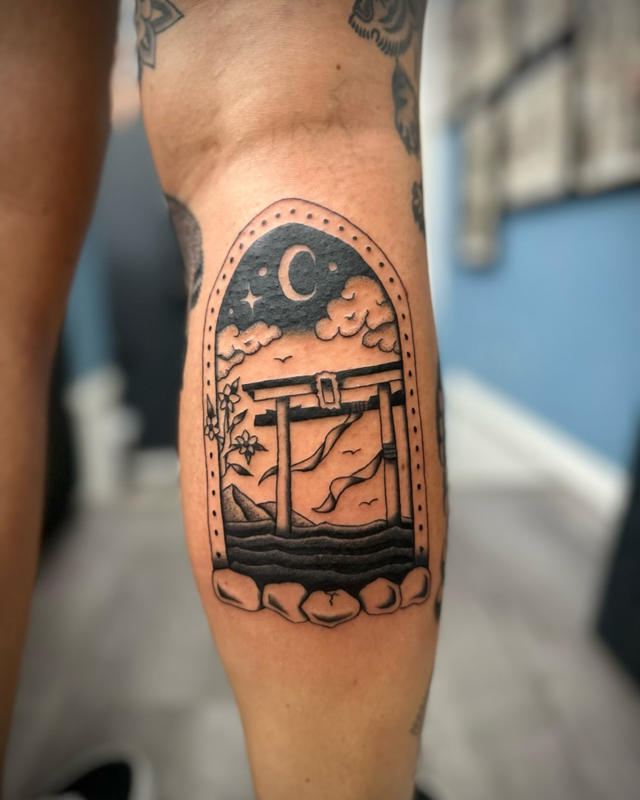 Torii gate and crescent moon dotwork tattoo on the forearm by rory
