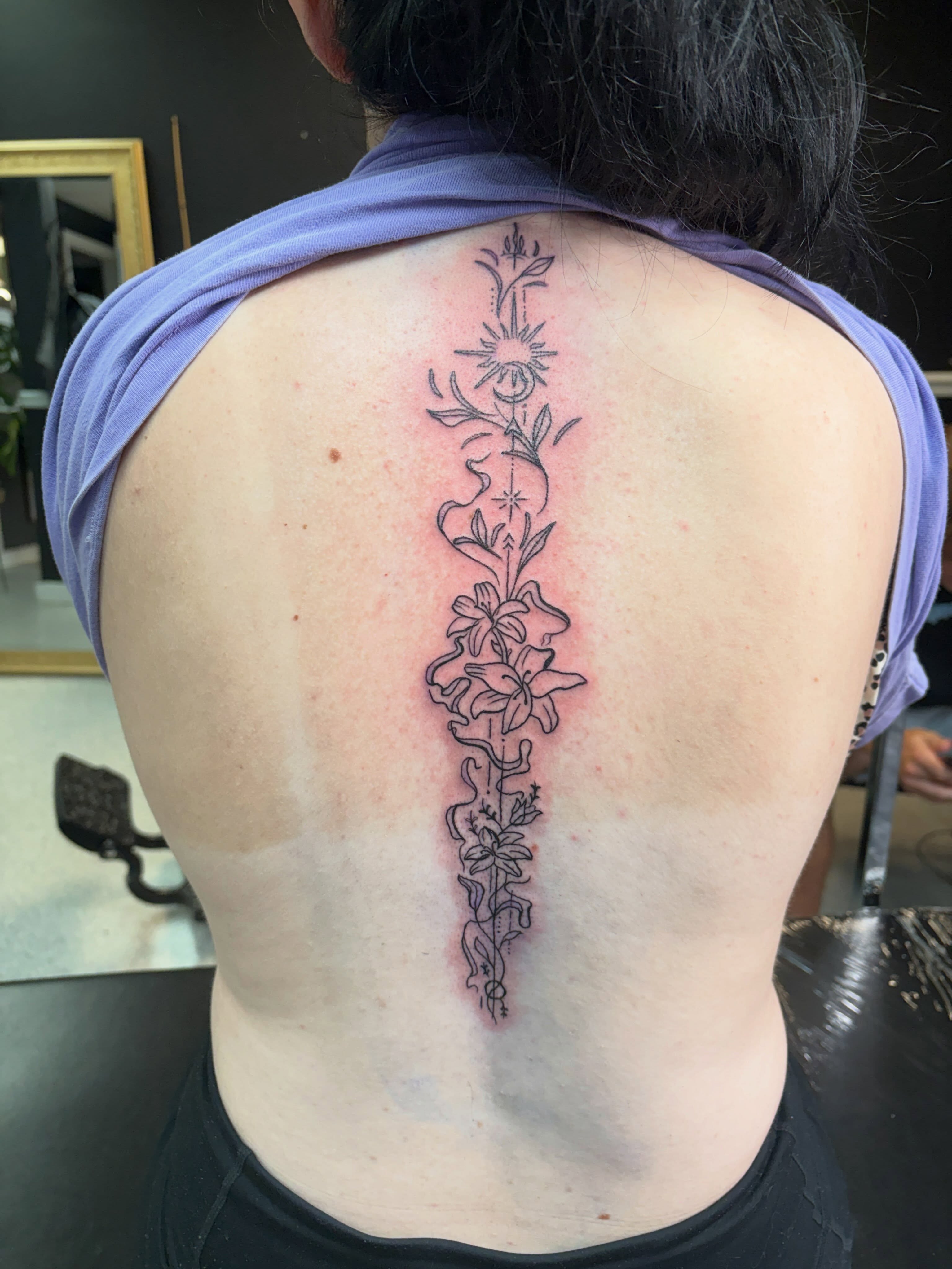 Floral arrangement black and grey tattoo on the back by Joshua Scott